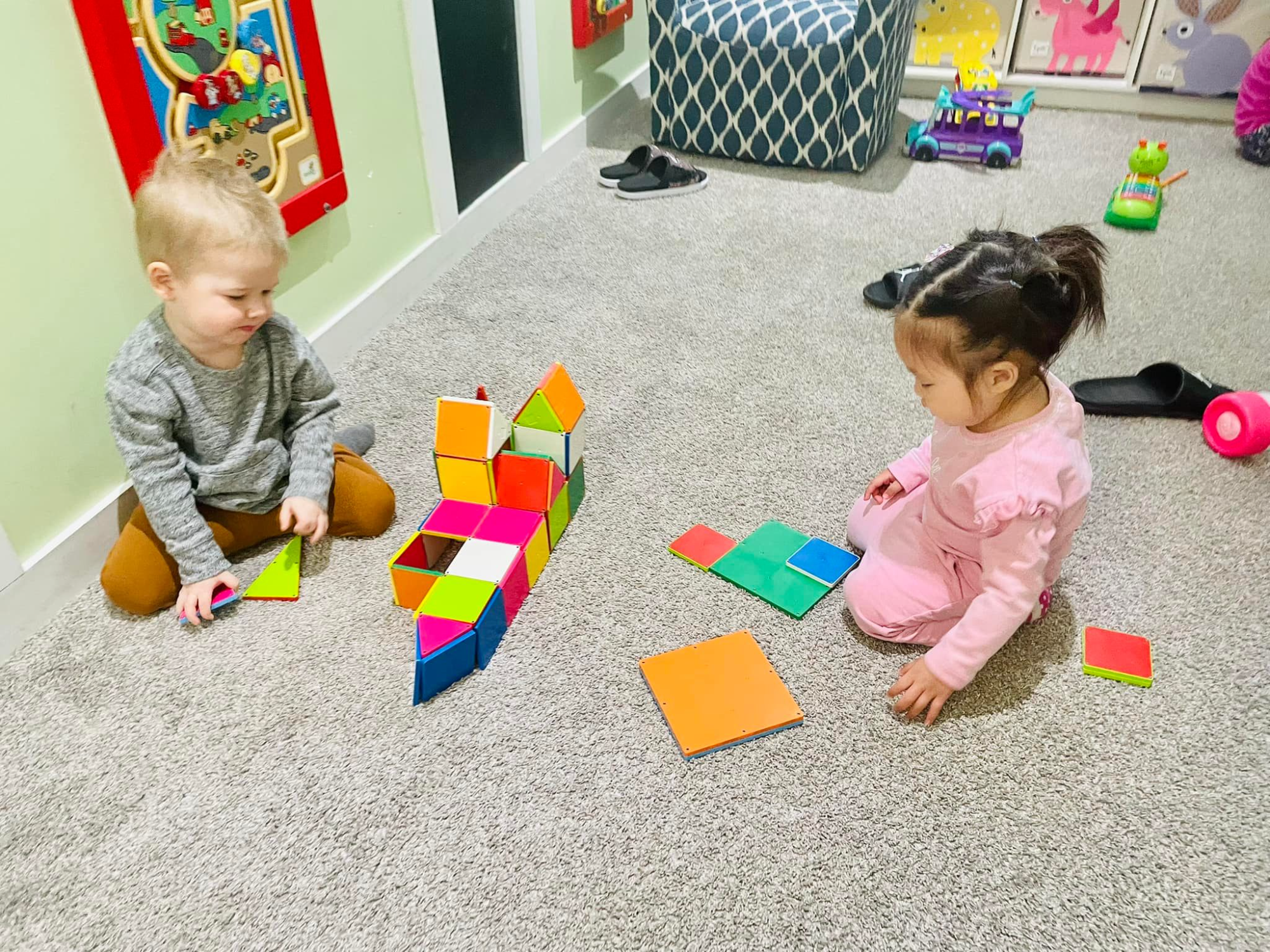 a couple of children playing with toys