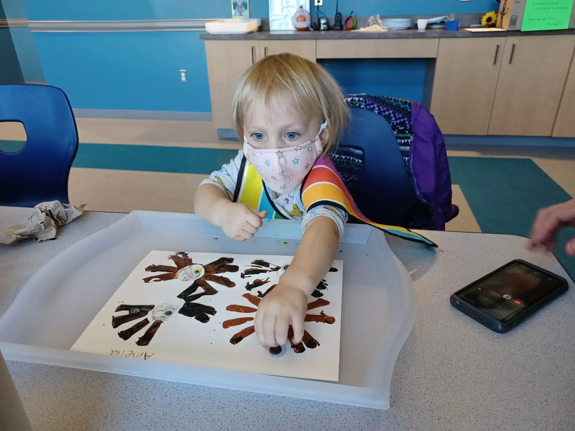 a child painting on a table