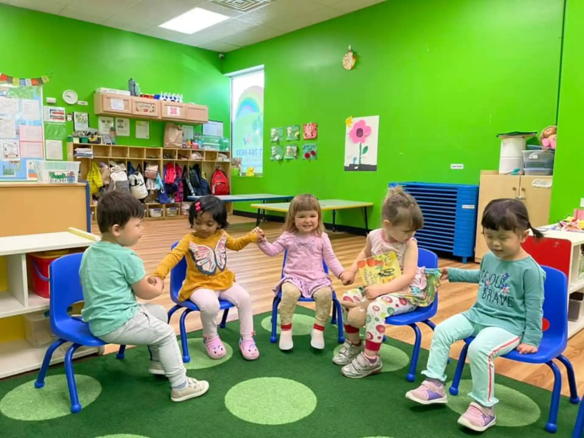 a group of children sitting in chairs