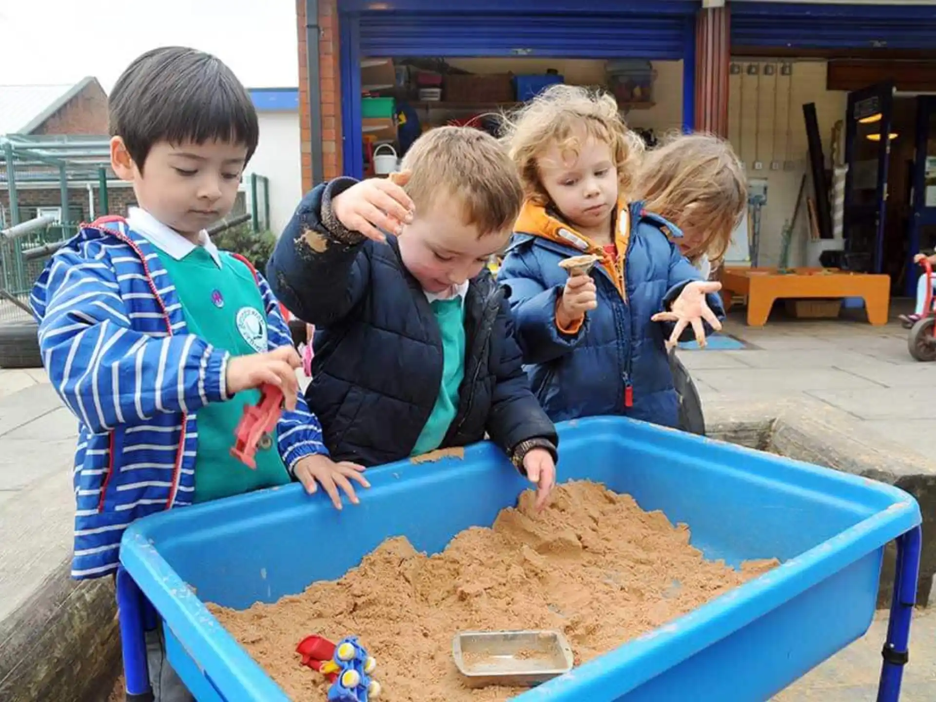 a group of children playing with sand