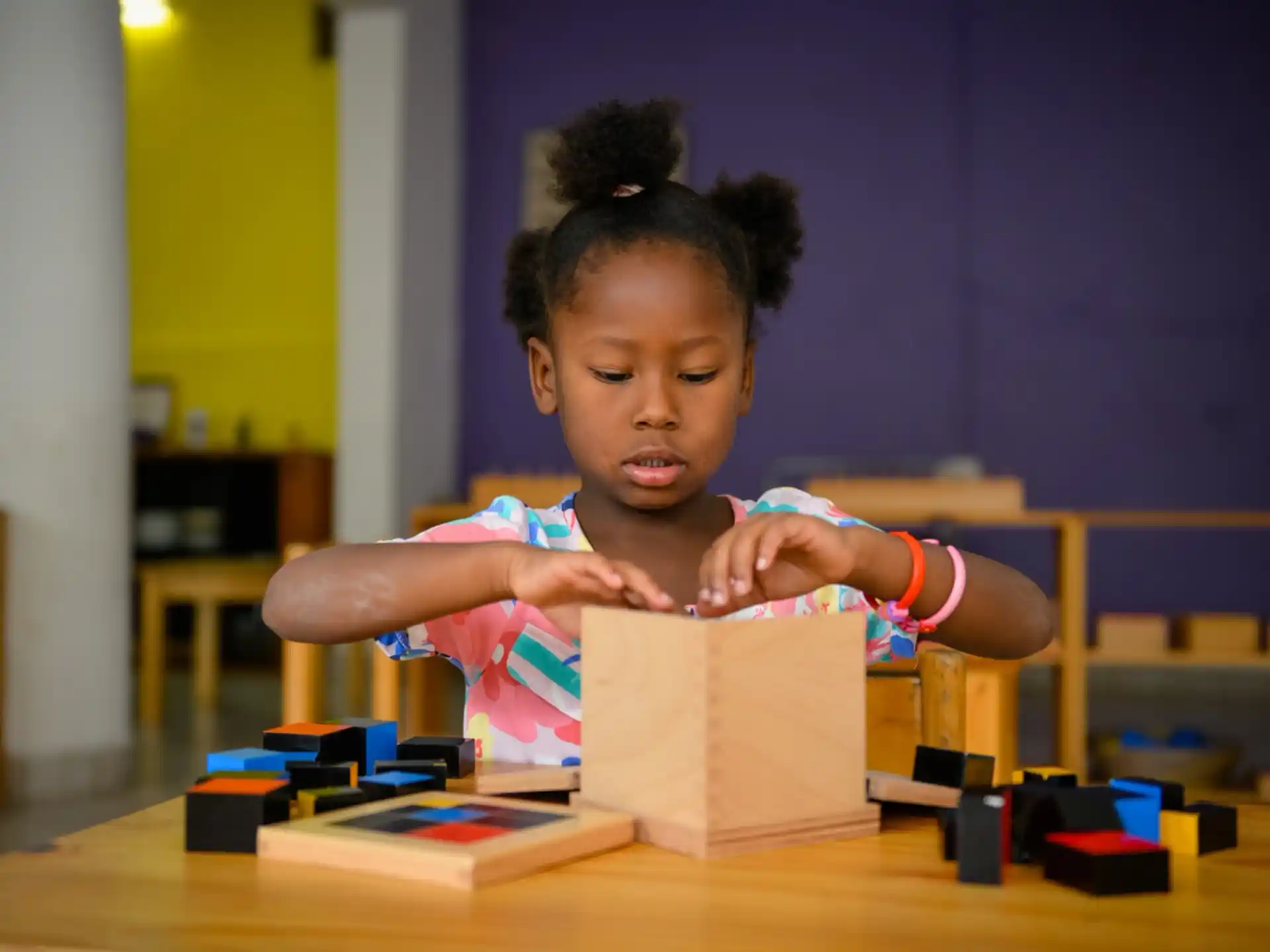 a girl playing with a toy