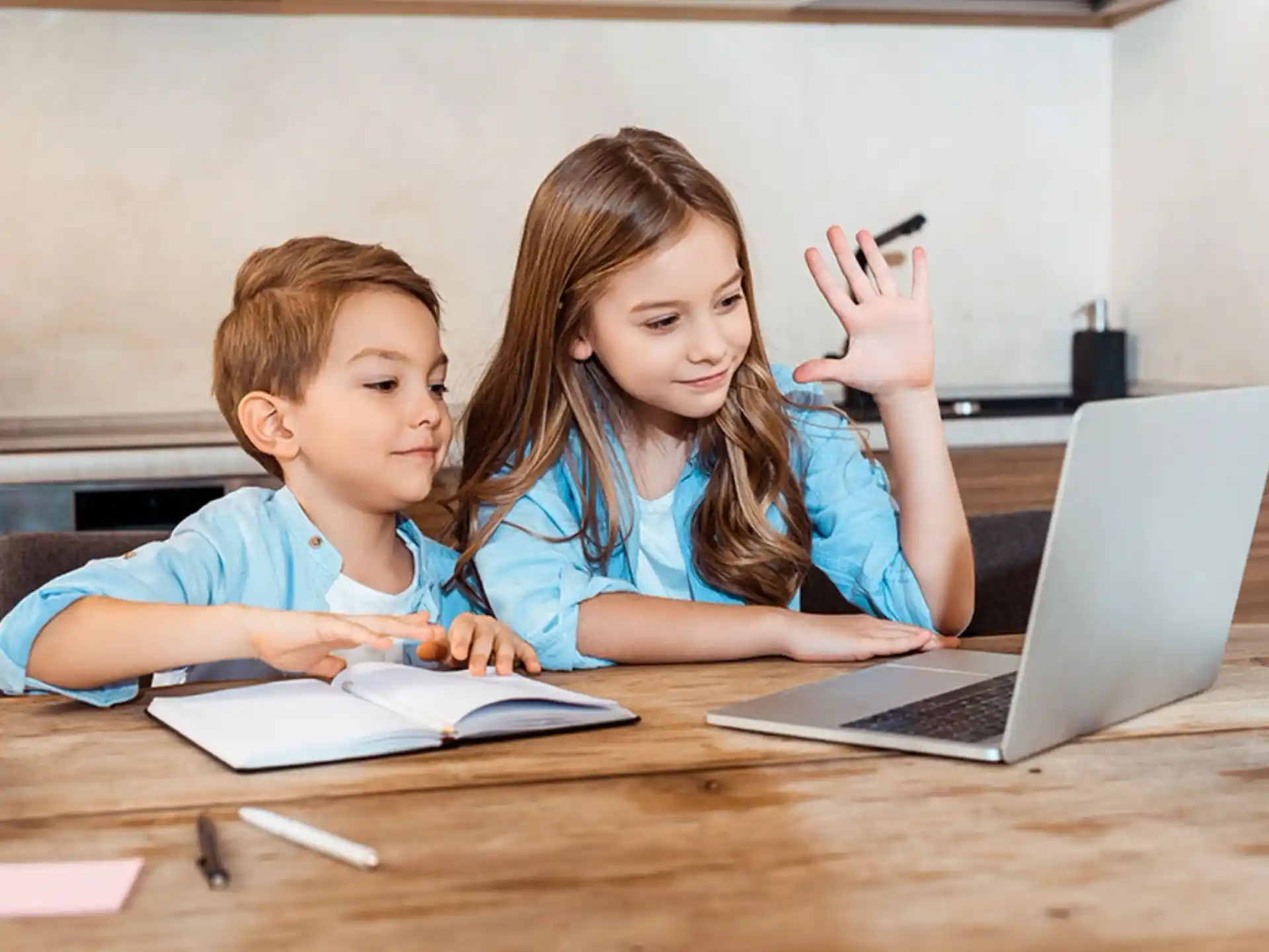 a person and a boy looking at a laptop