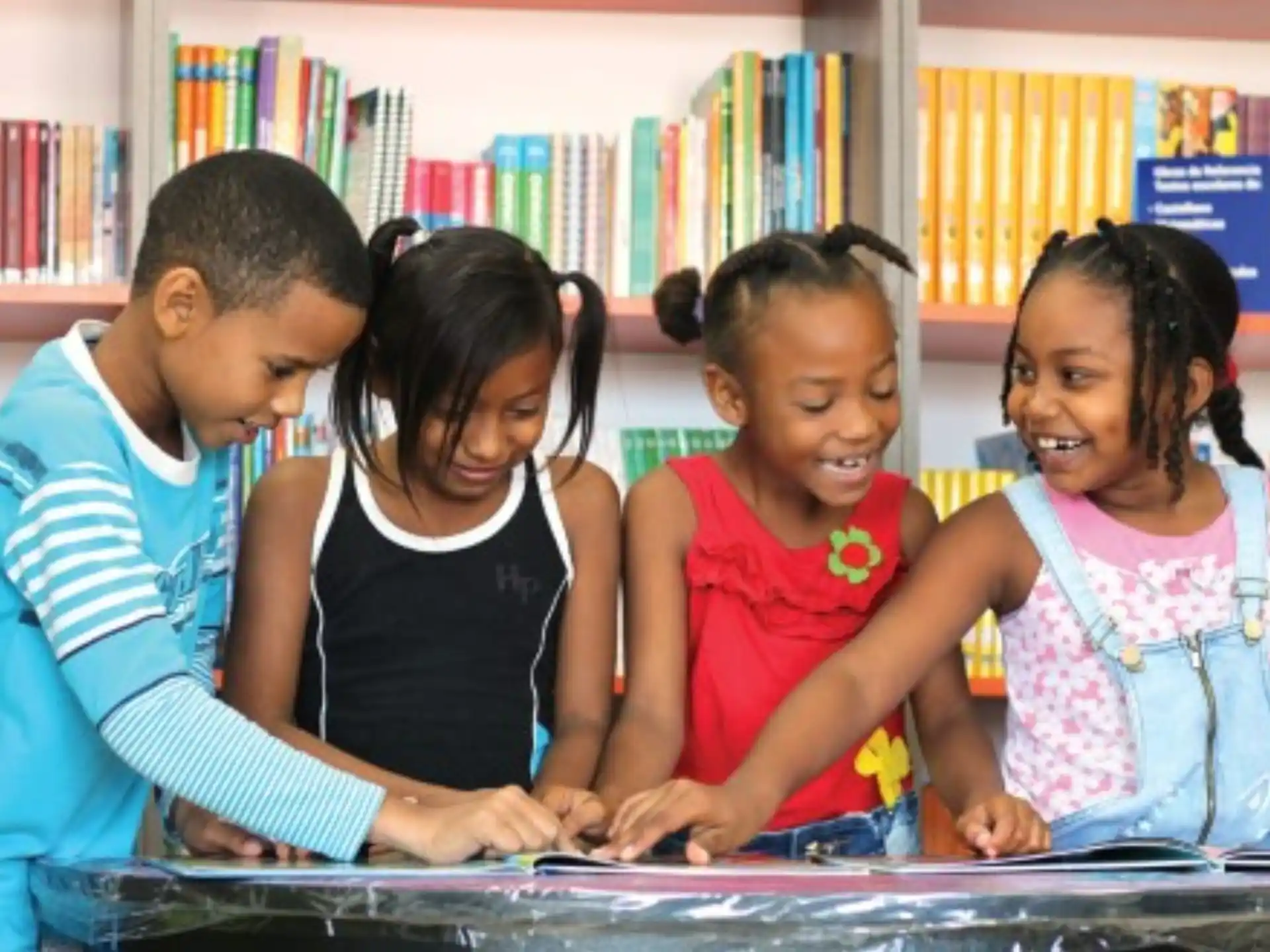 a group of children looking at a book