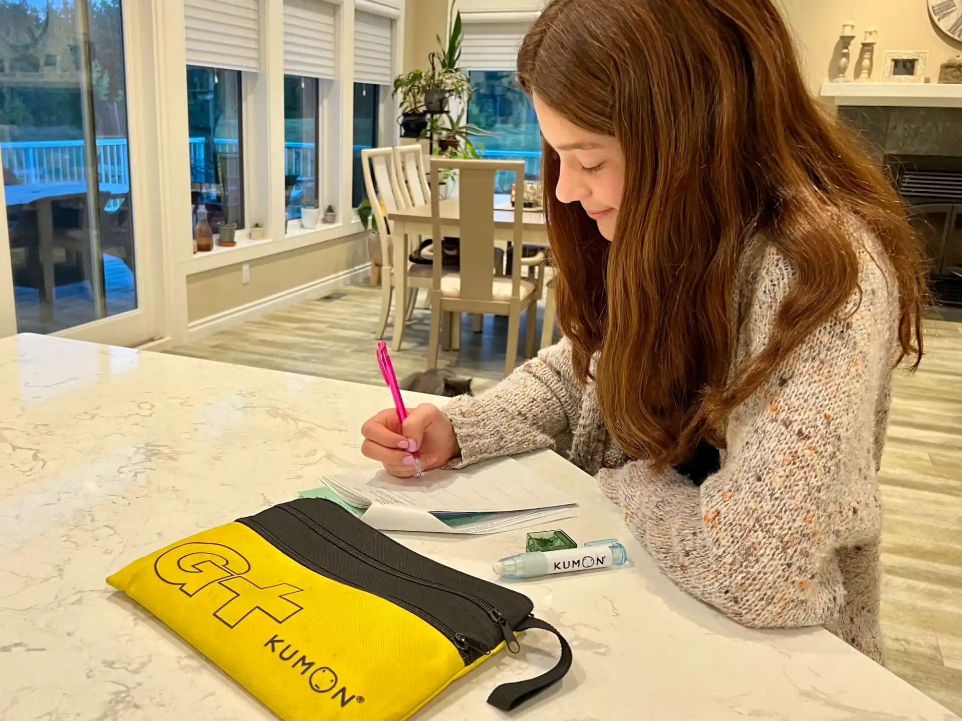 a woman writing on a book