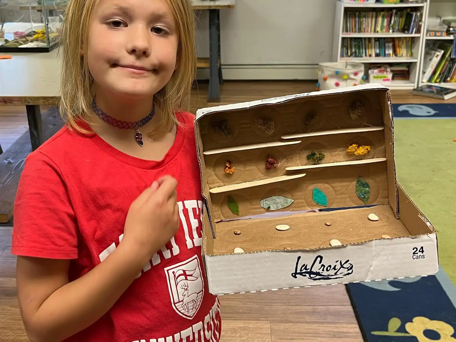 a girl holding a box