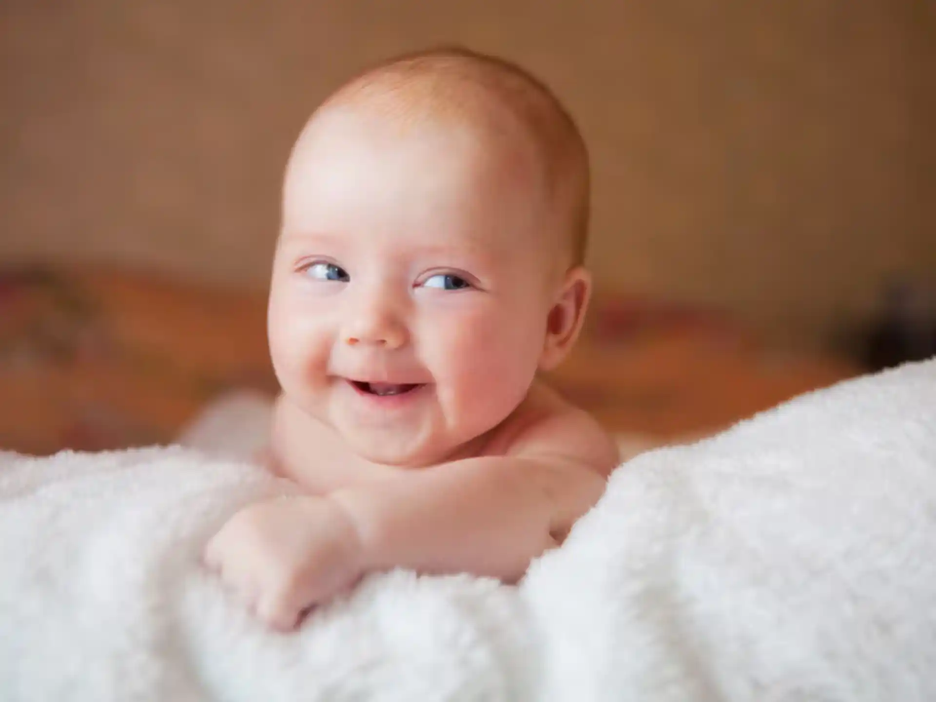 a baby lying on a blanket
