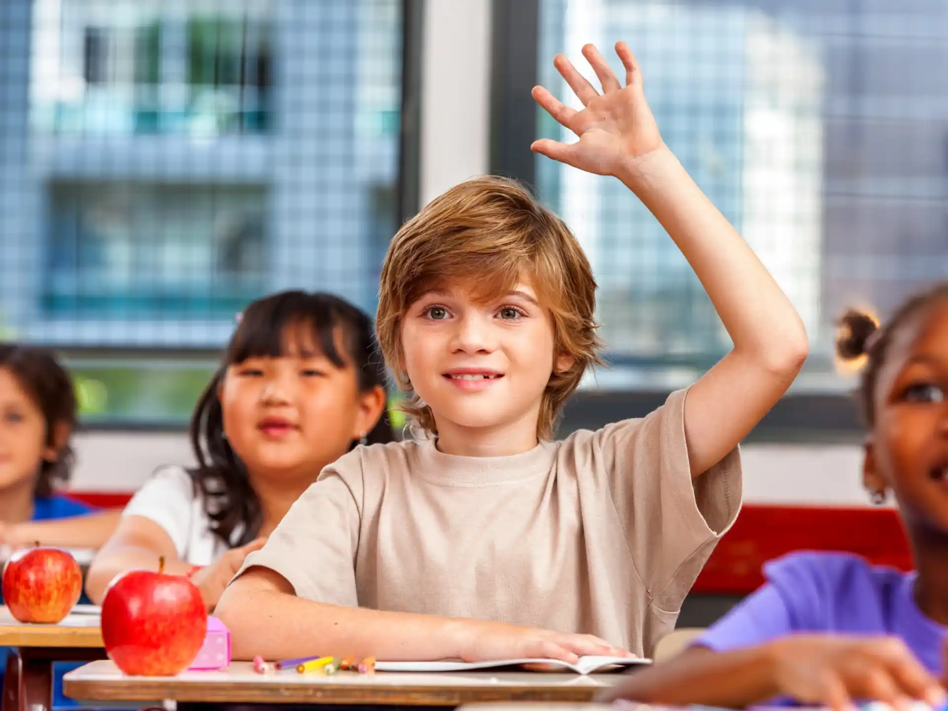 a group of children raising their hands