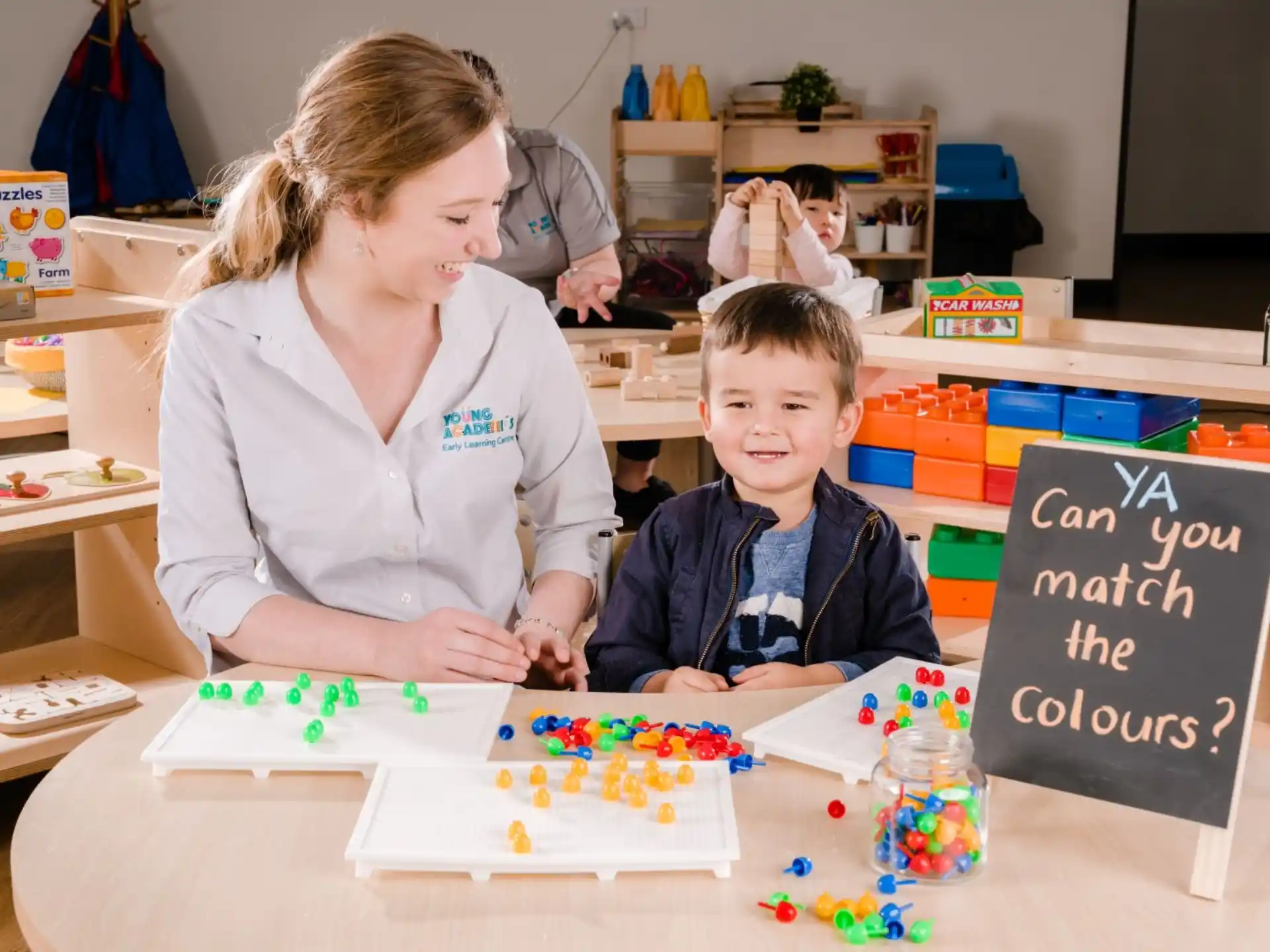 a woman and a boy playing with toys