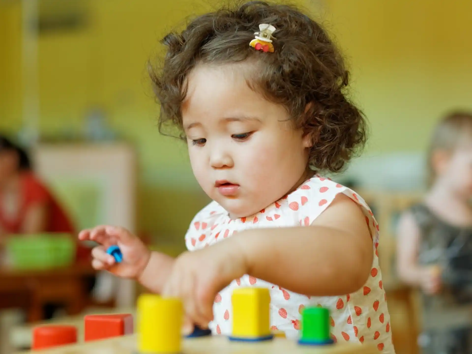 a young girl playing with toys
