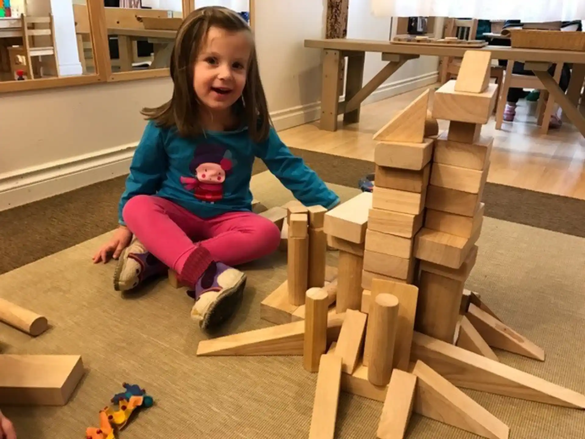 a girl sitting on a wooden structure