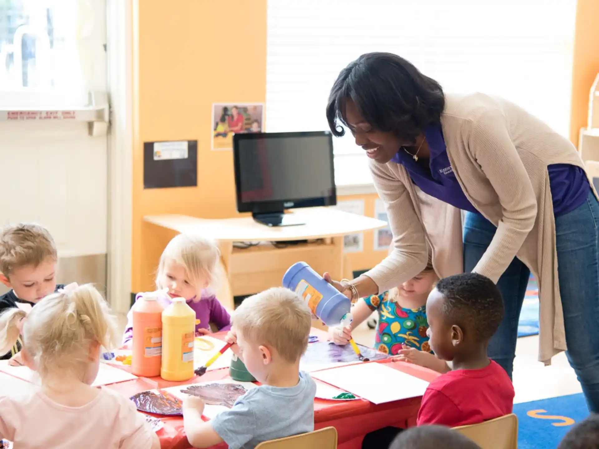 a person helping a group of children