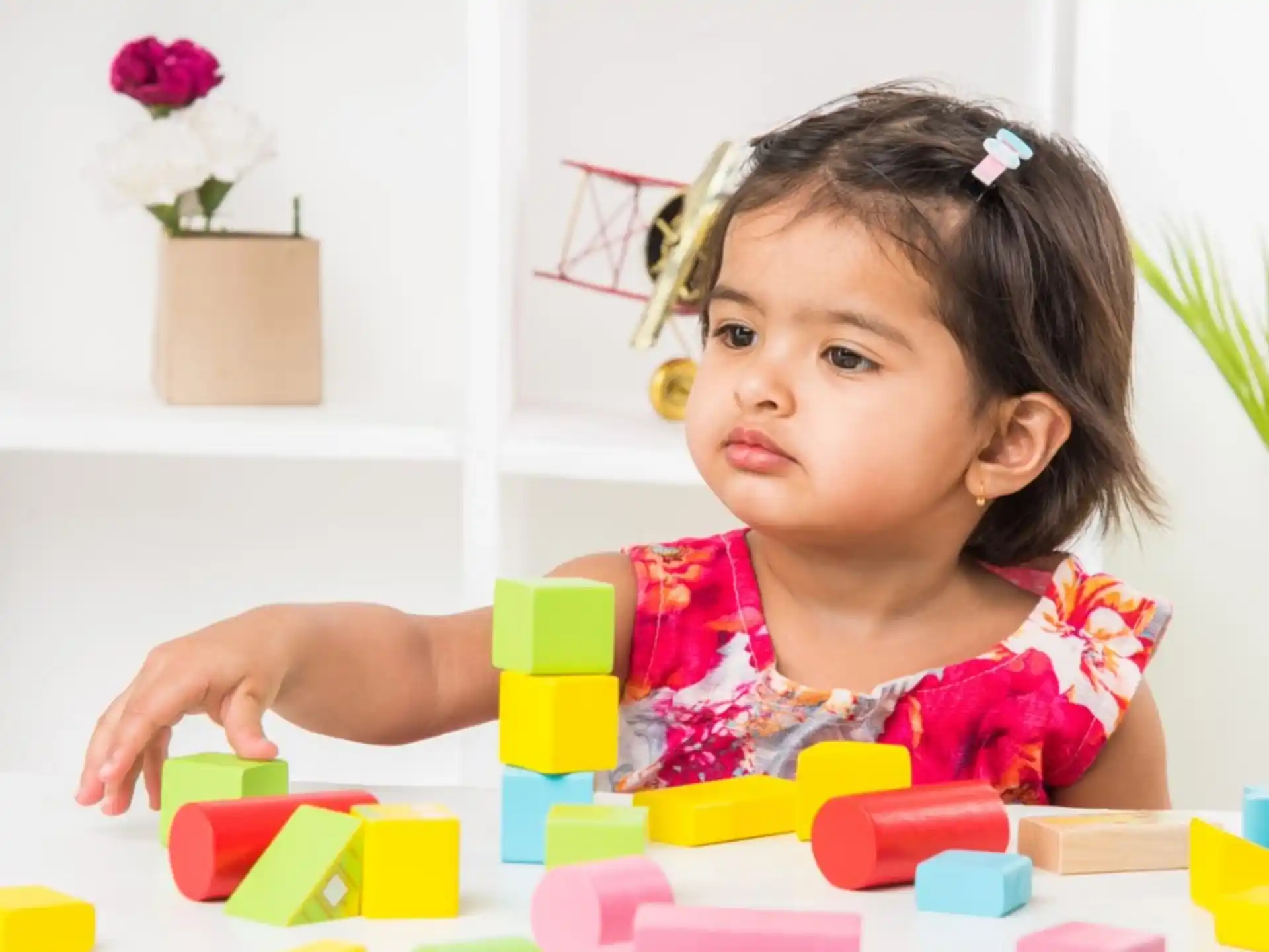 a girl playing with blocks