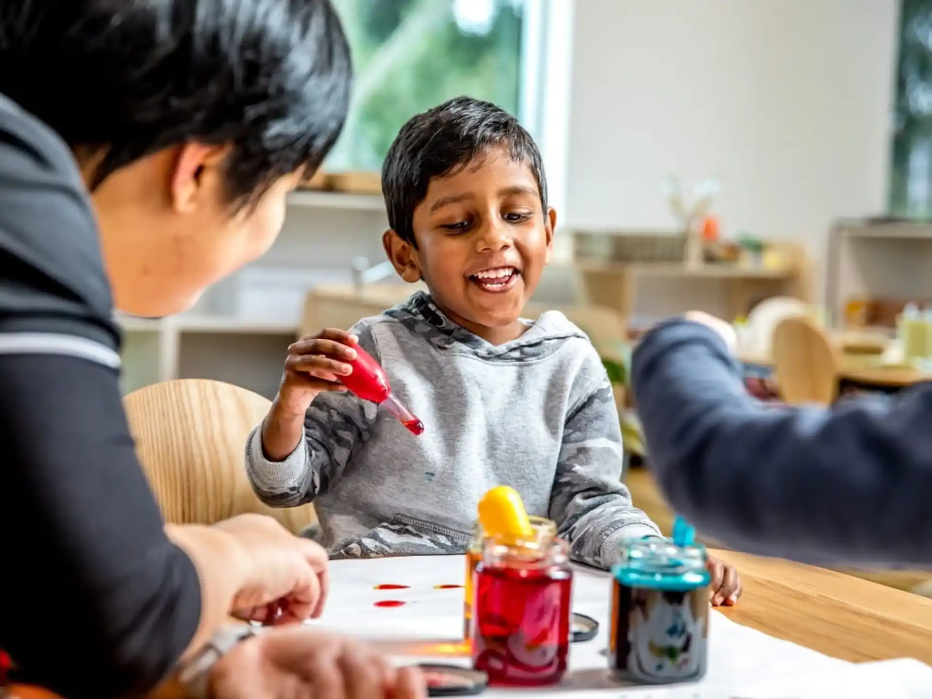 a person and a child playing with a toy