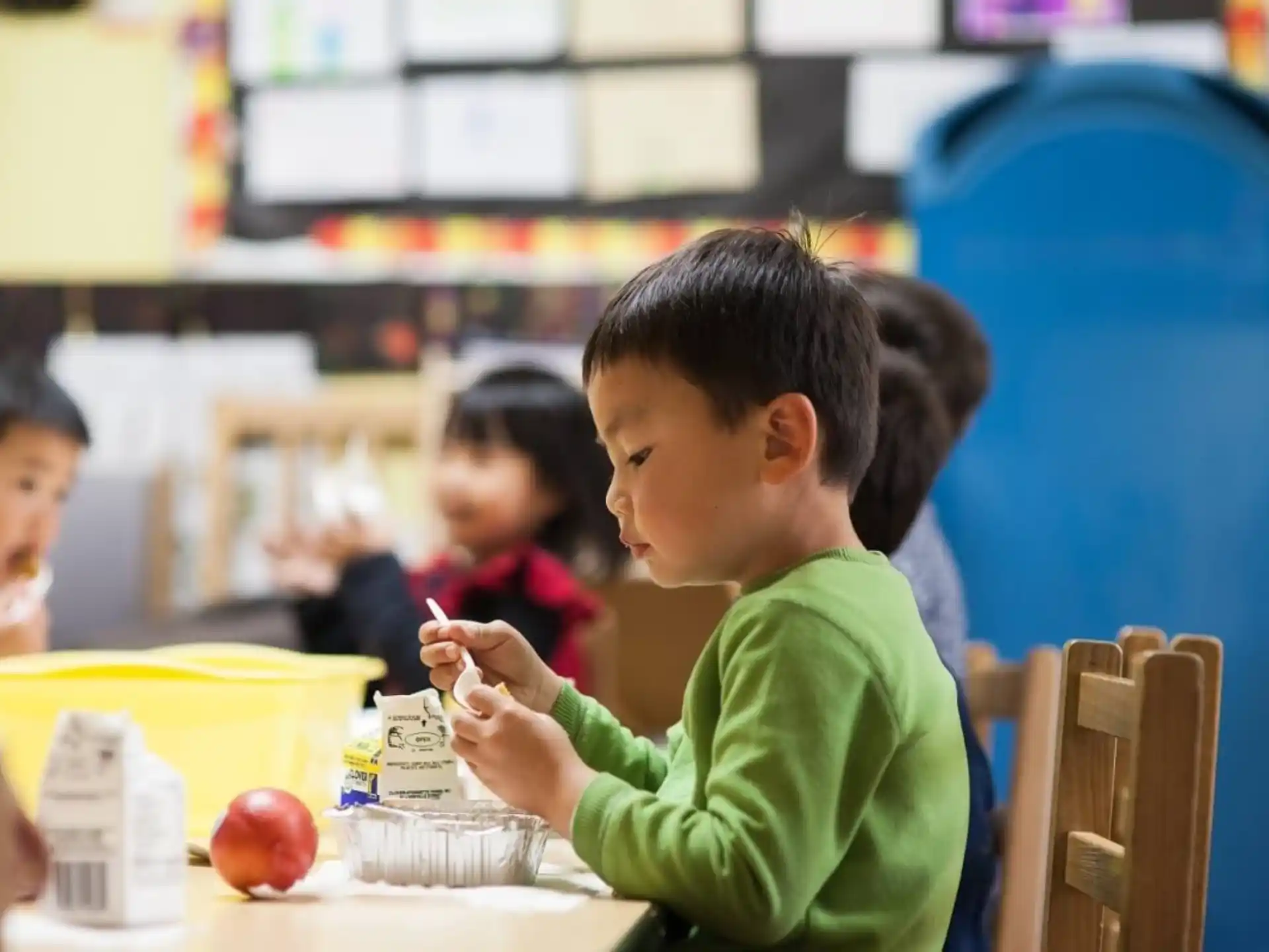 a young boy eating a fruit