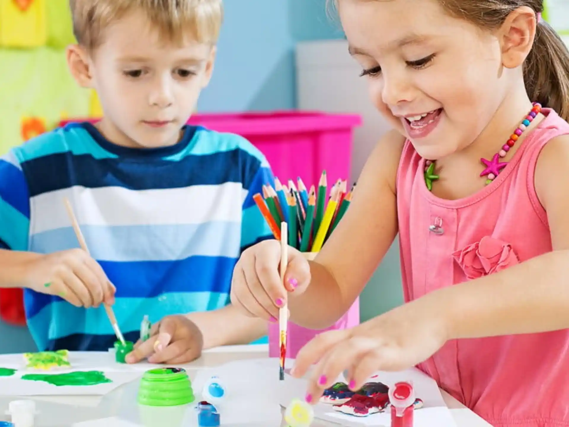a couple of children painting