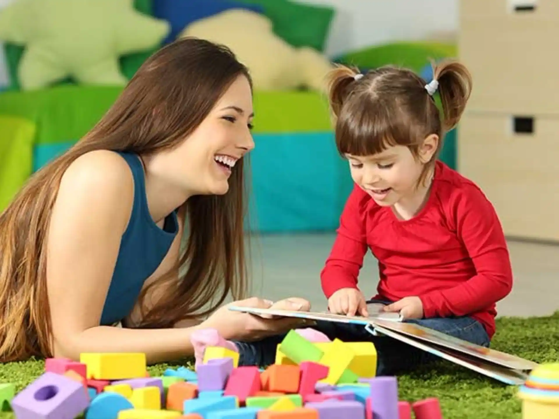 a woman and a child playing with blocks