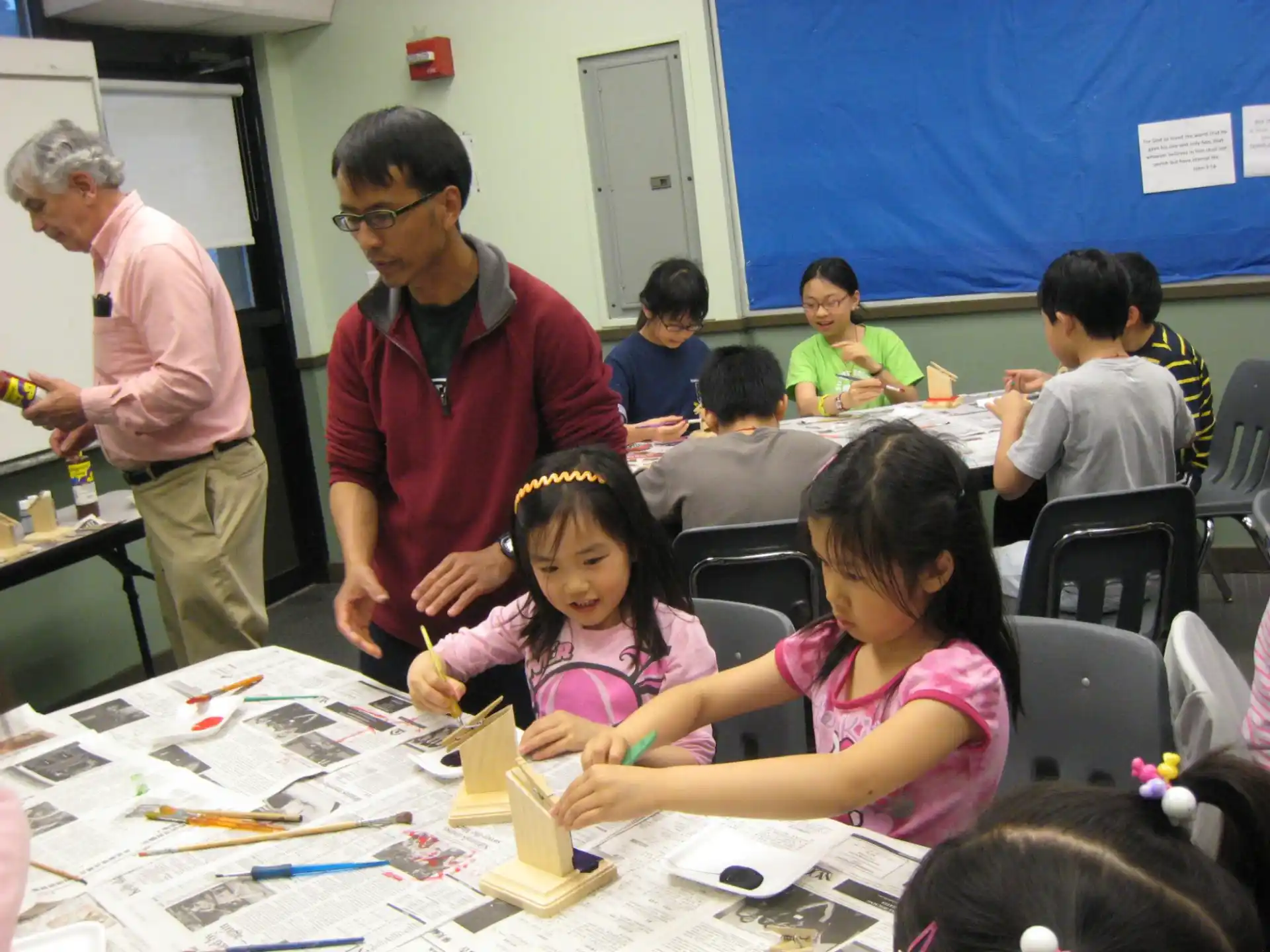 a group of children sitting at a table
