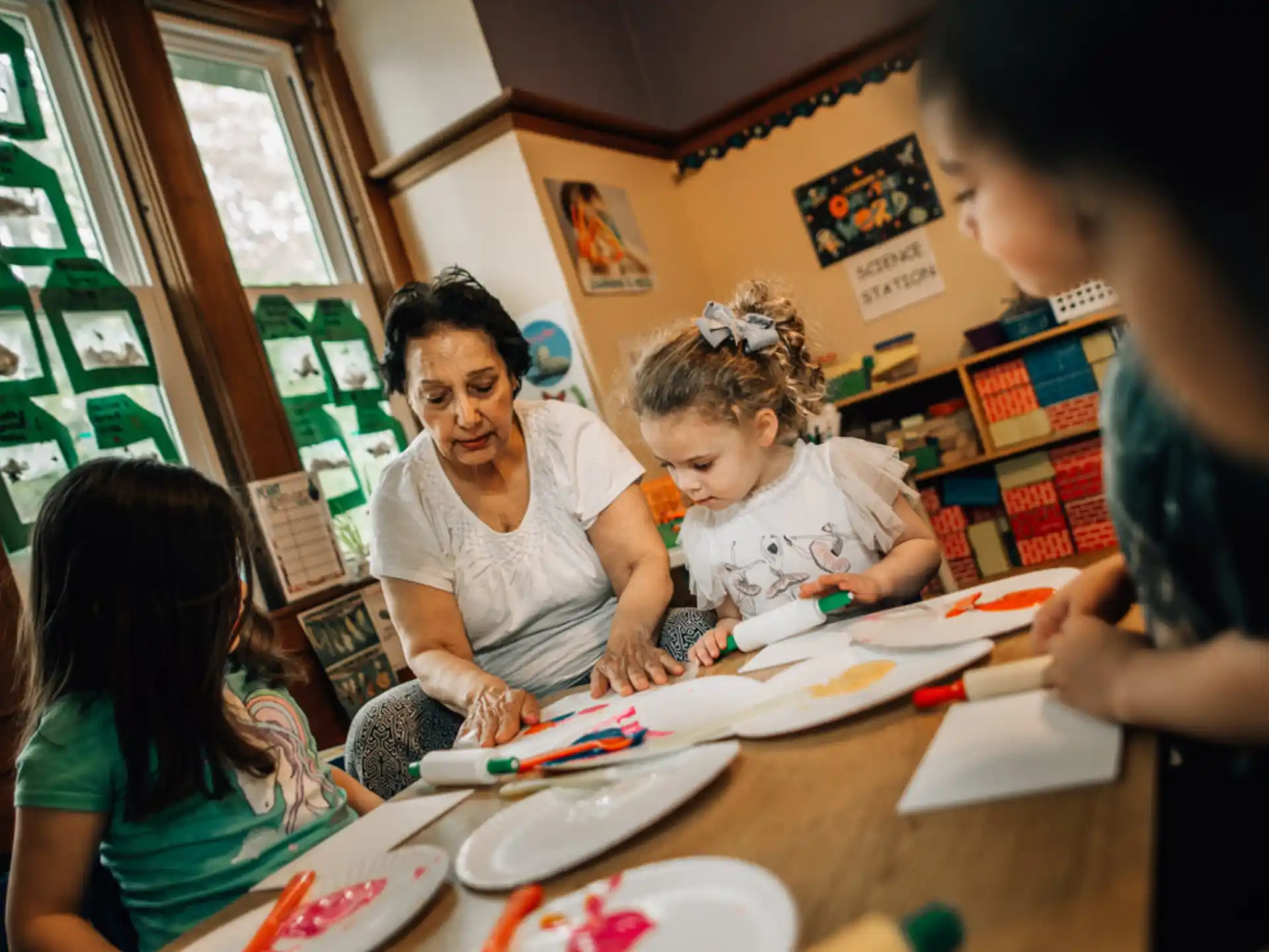 a person and a couple of children painting