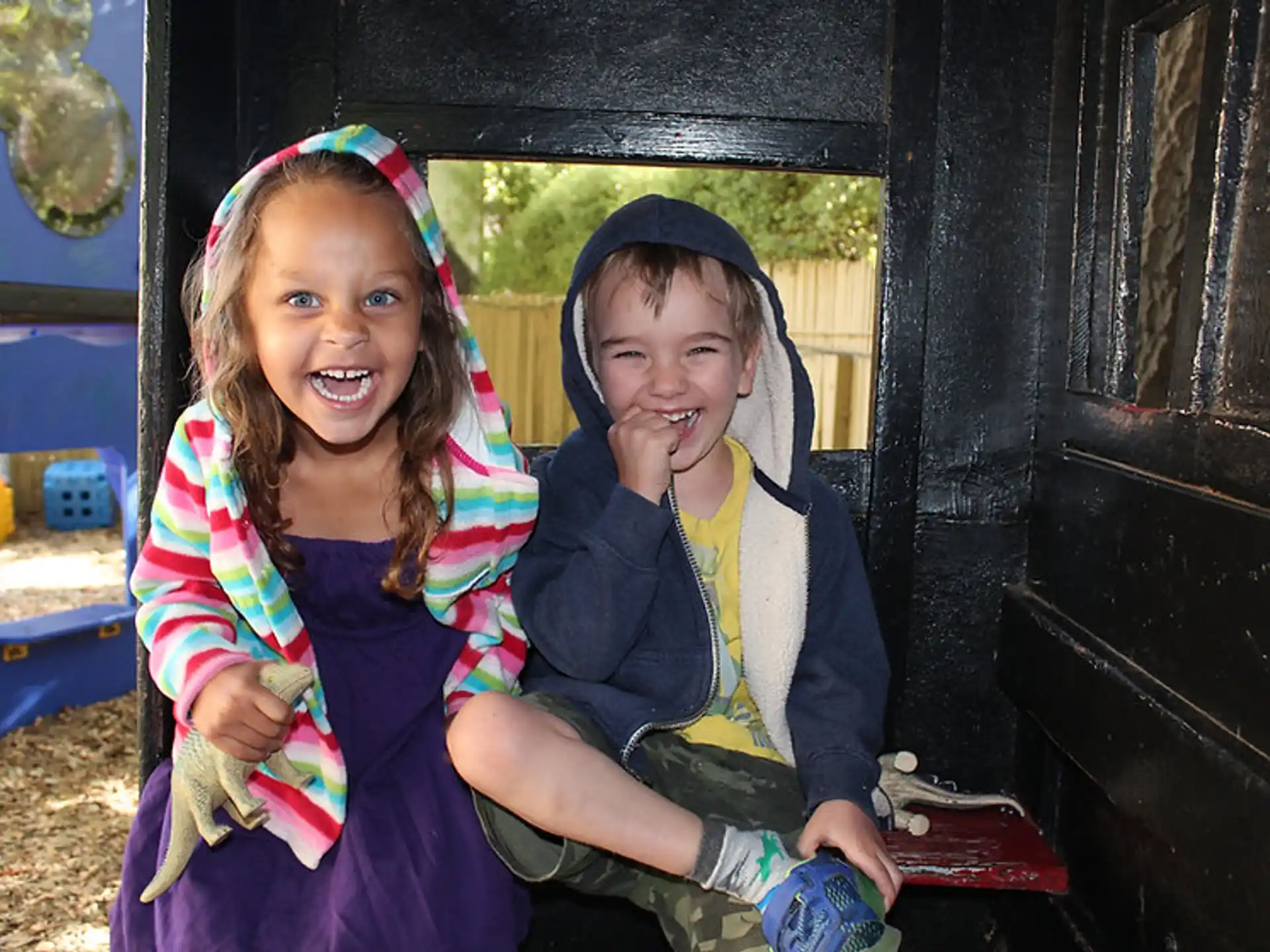 a couple of girls sitting in a vehicle