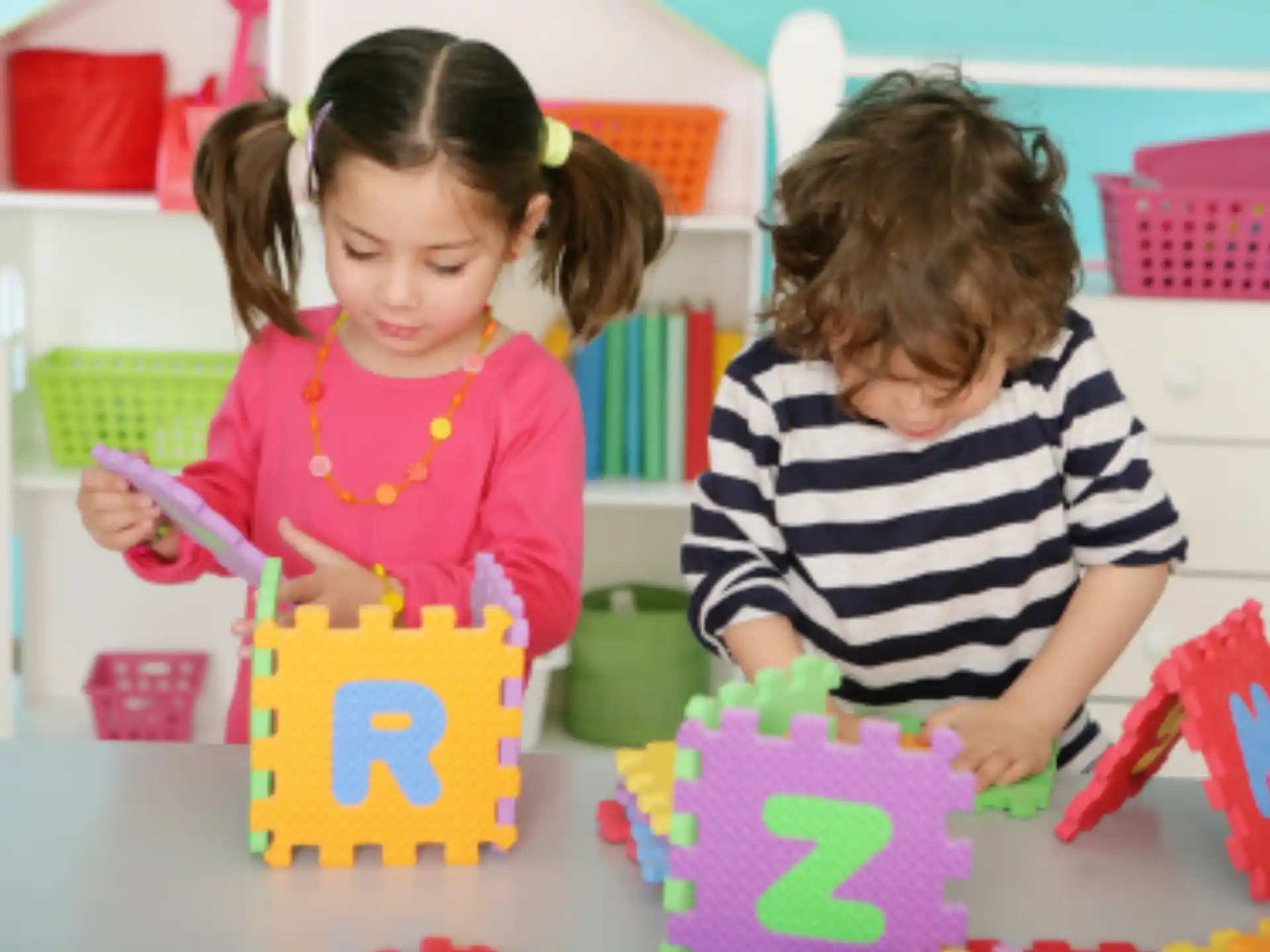 a couple of young girls playing with toys