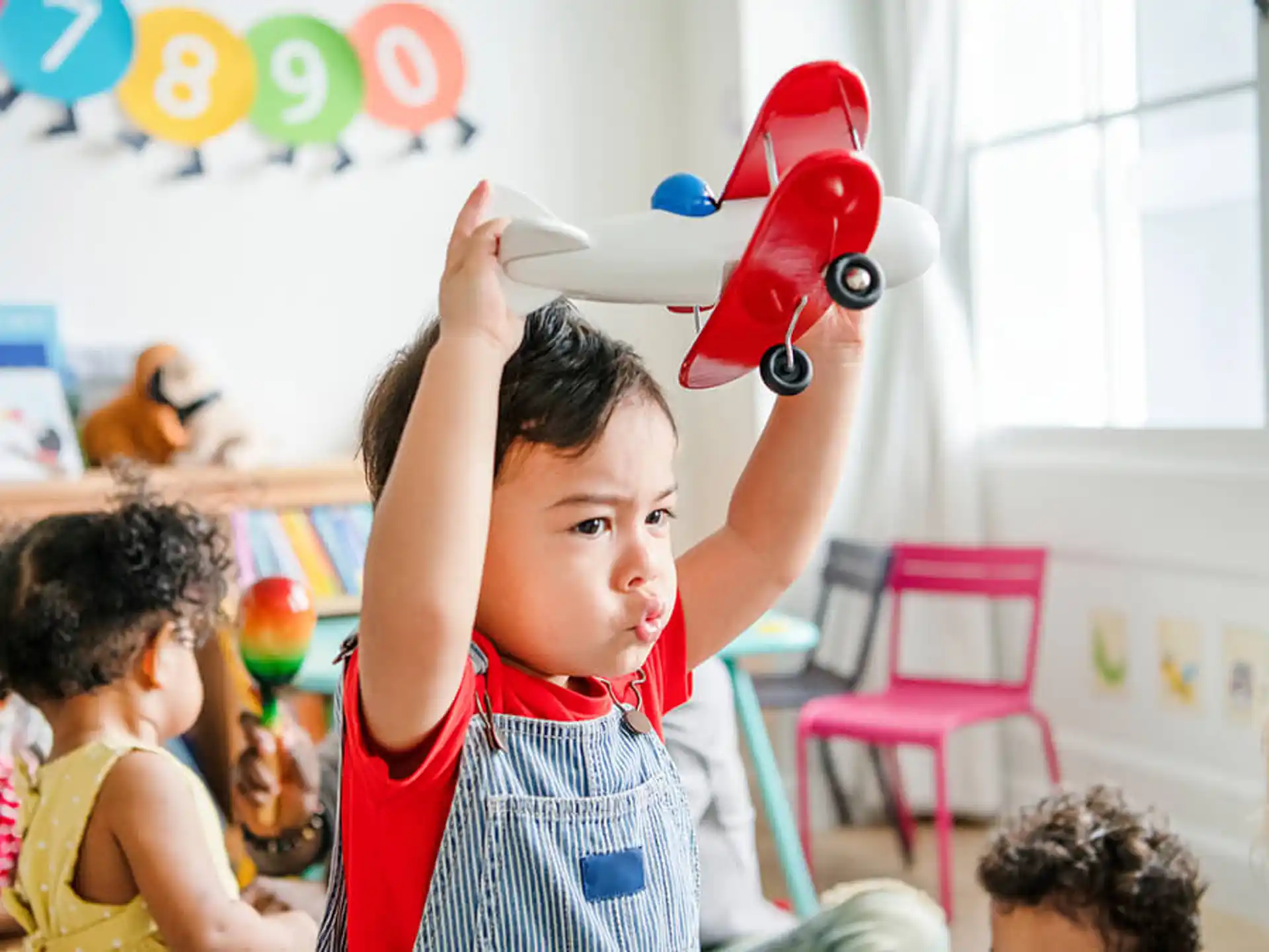 a person holding a red toy