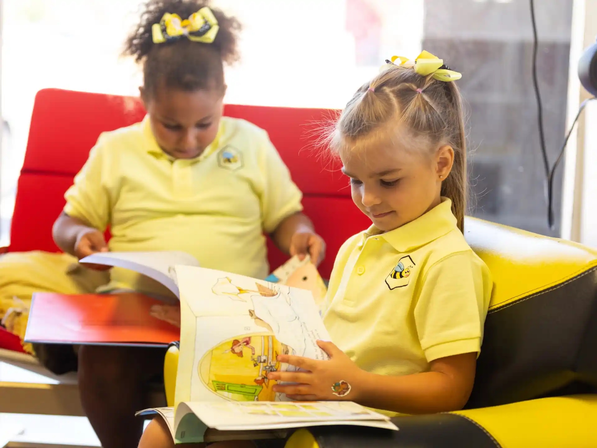 a couple of young girls reading books