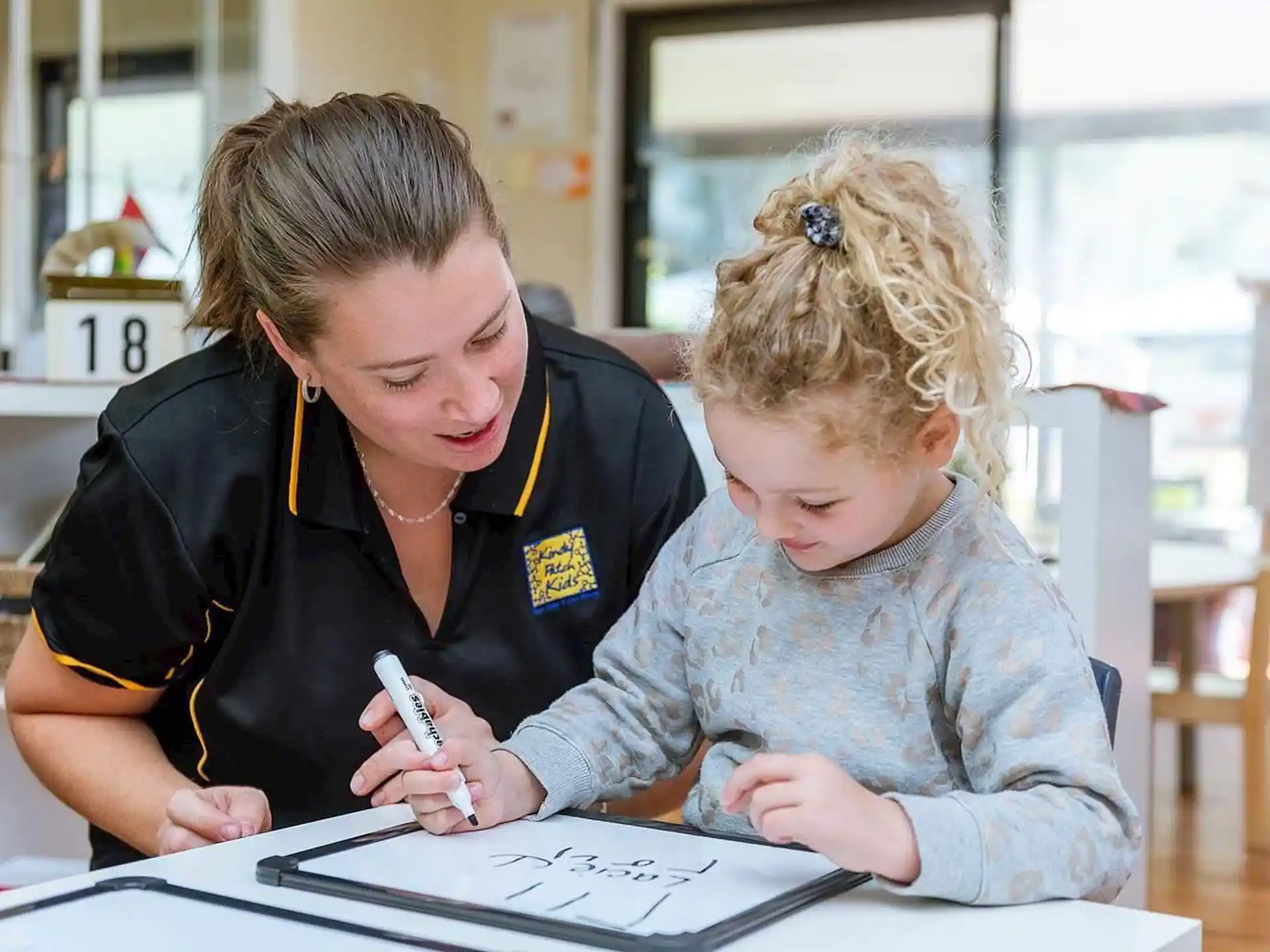 a person and a child looking at a paper