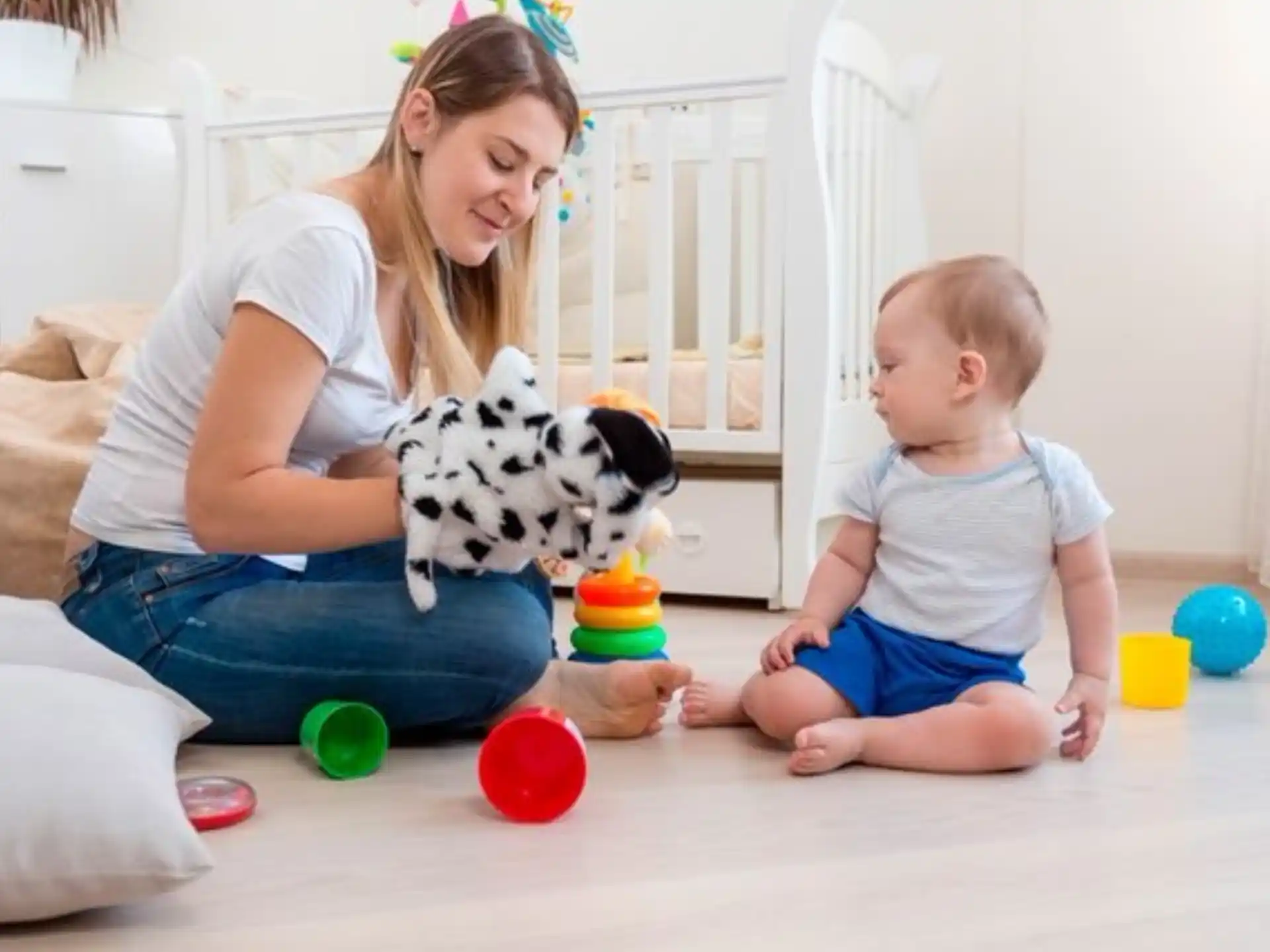 a person and a child playing with toys on the floor