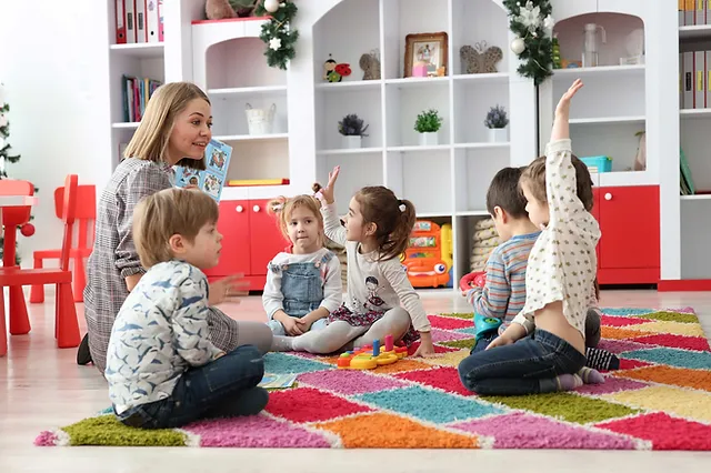 a person and several children sitting on the floor