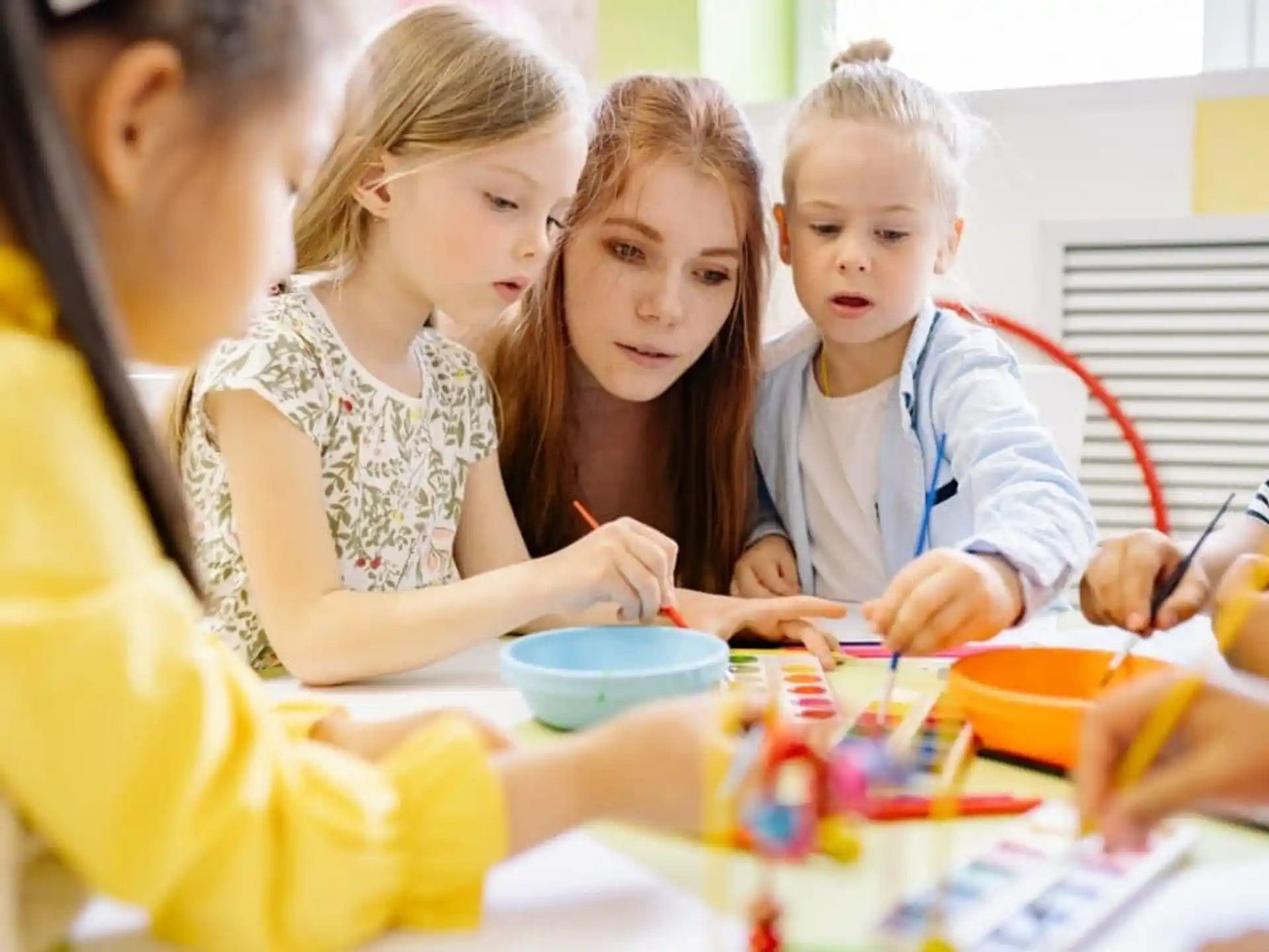 a group of children sitting at a table