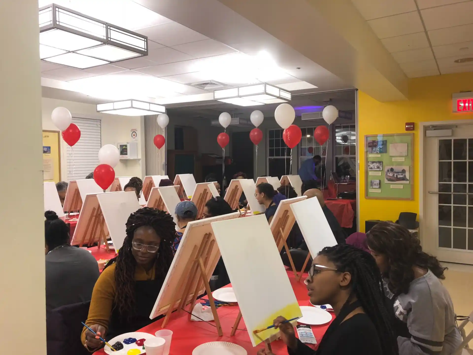 a group of people at a table with balloons