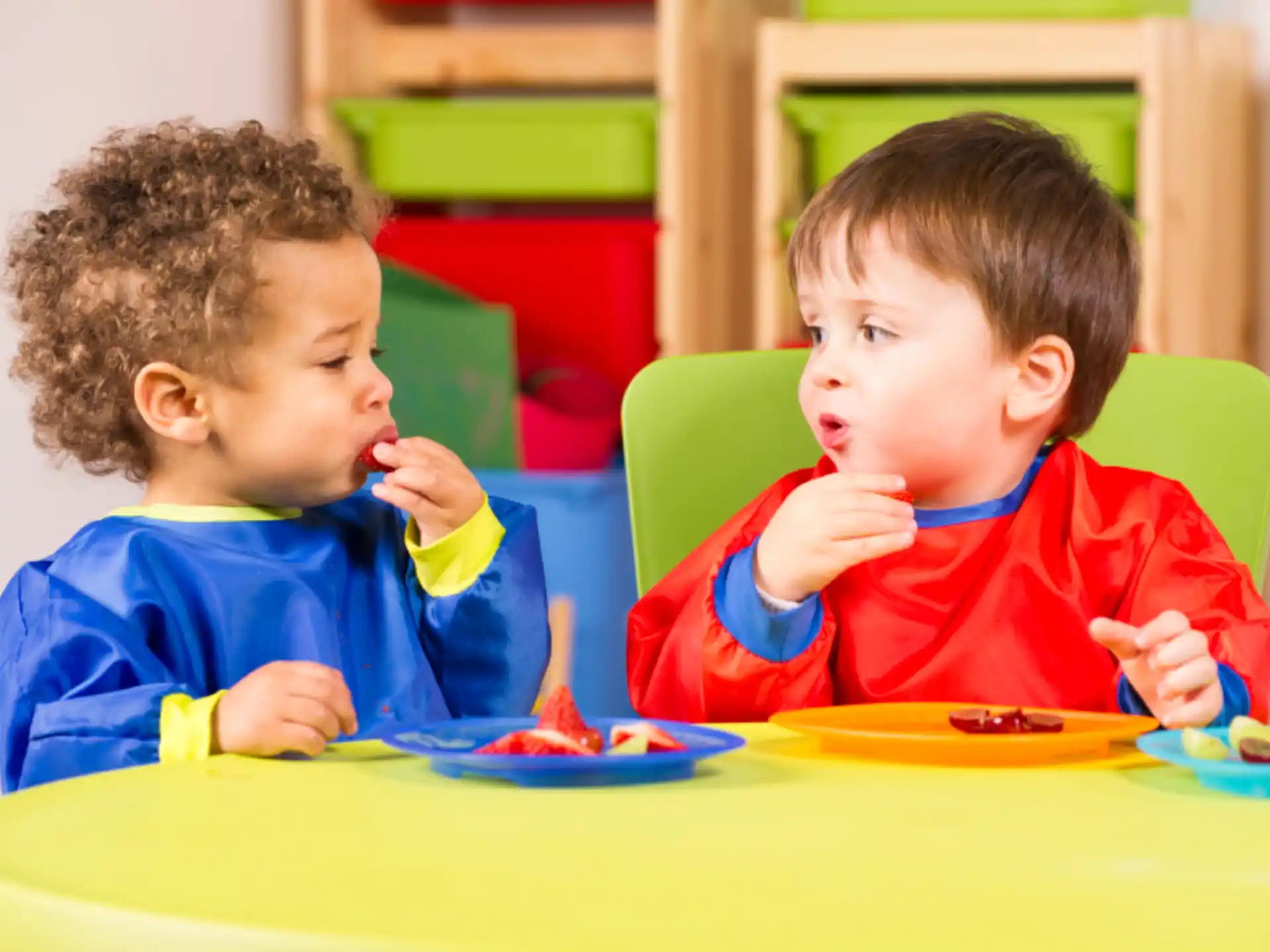 two boys eating at a table