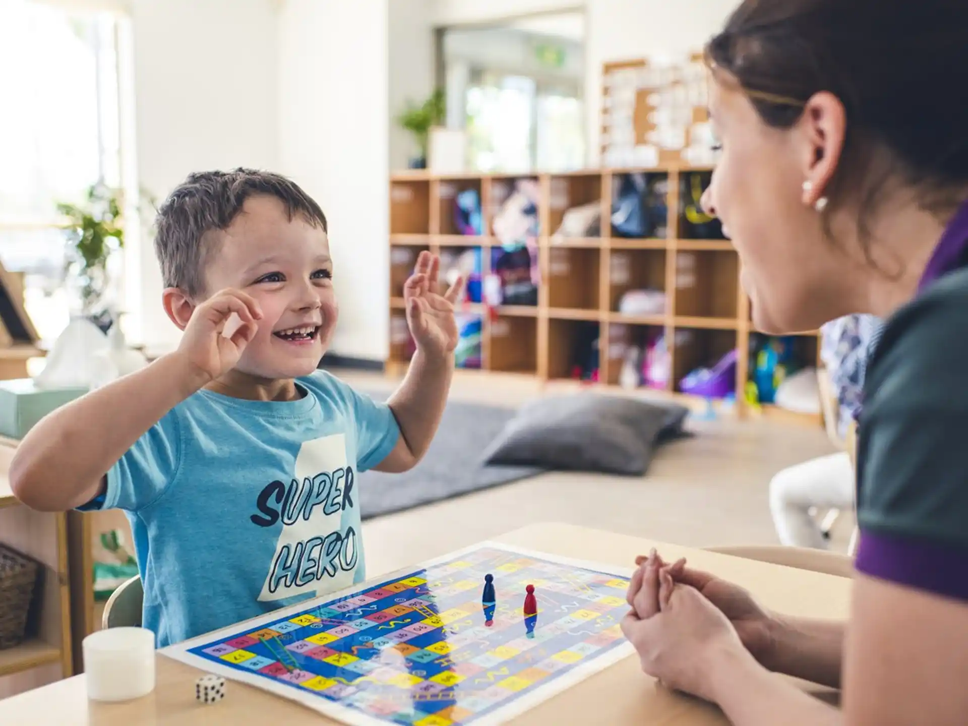 a person and a child playing a board game