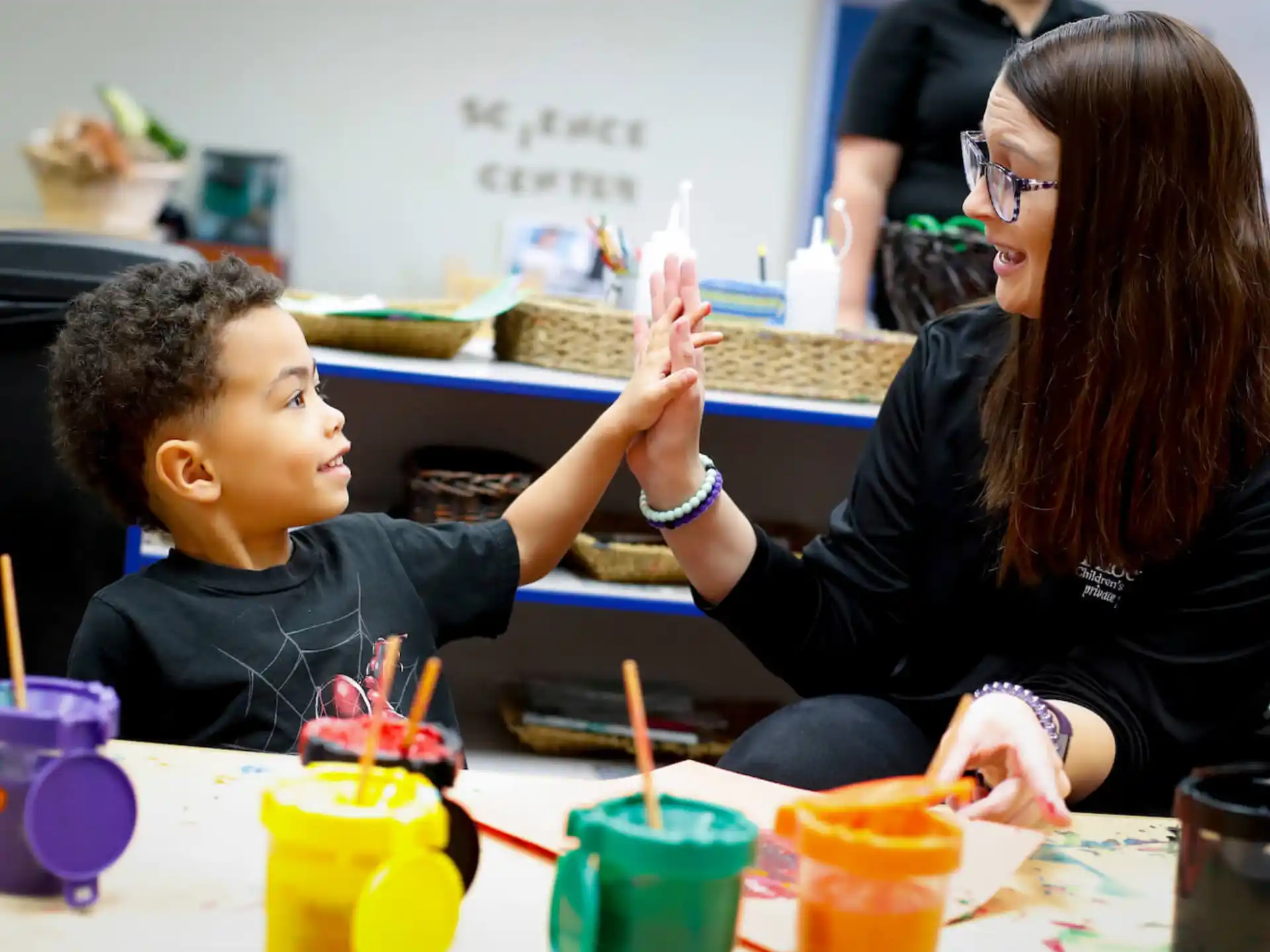 a person and a child painting