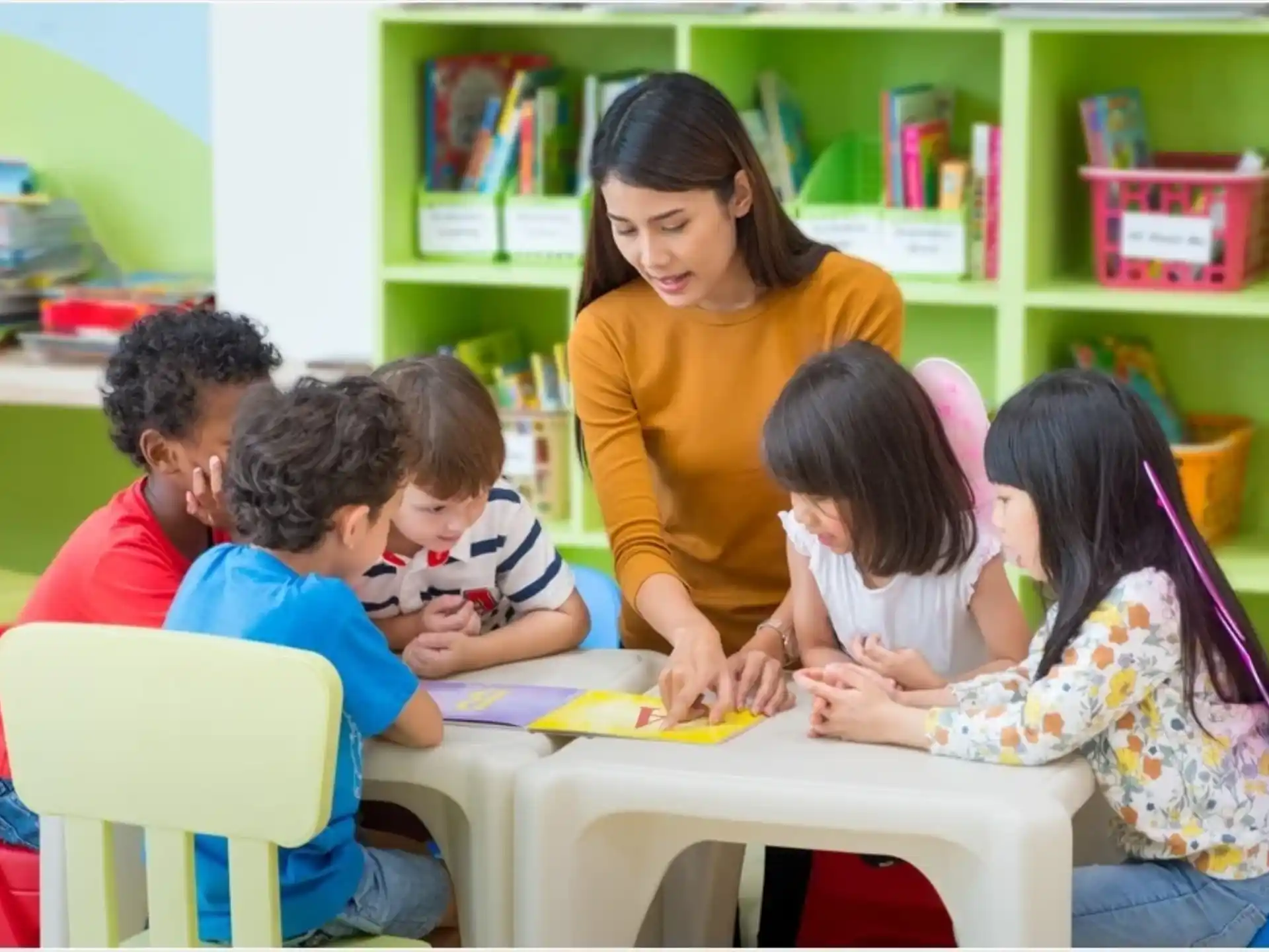 a person and several children sitting at a table