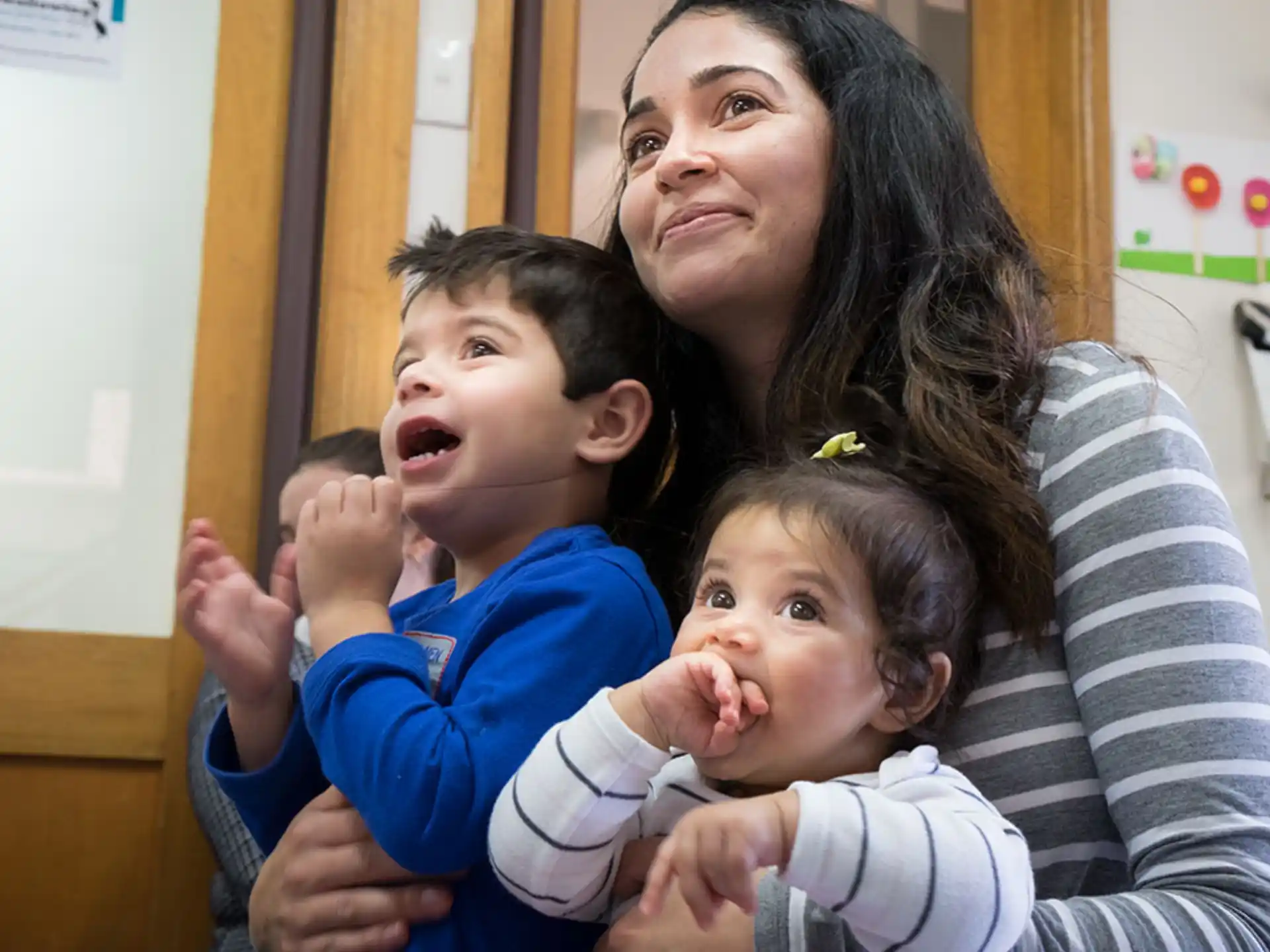 a person holding two children