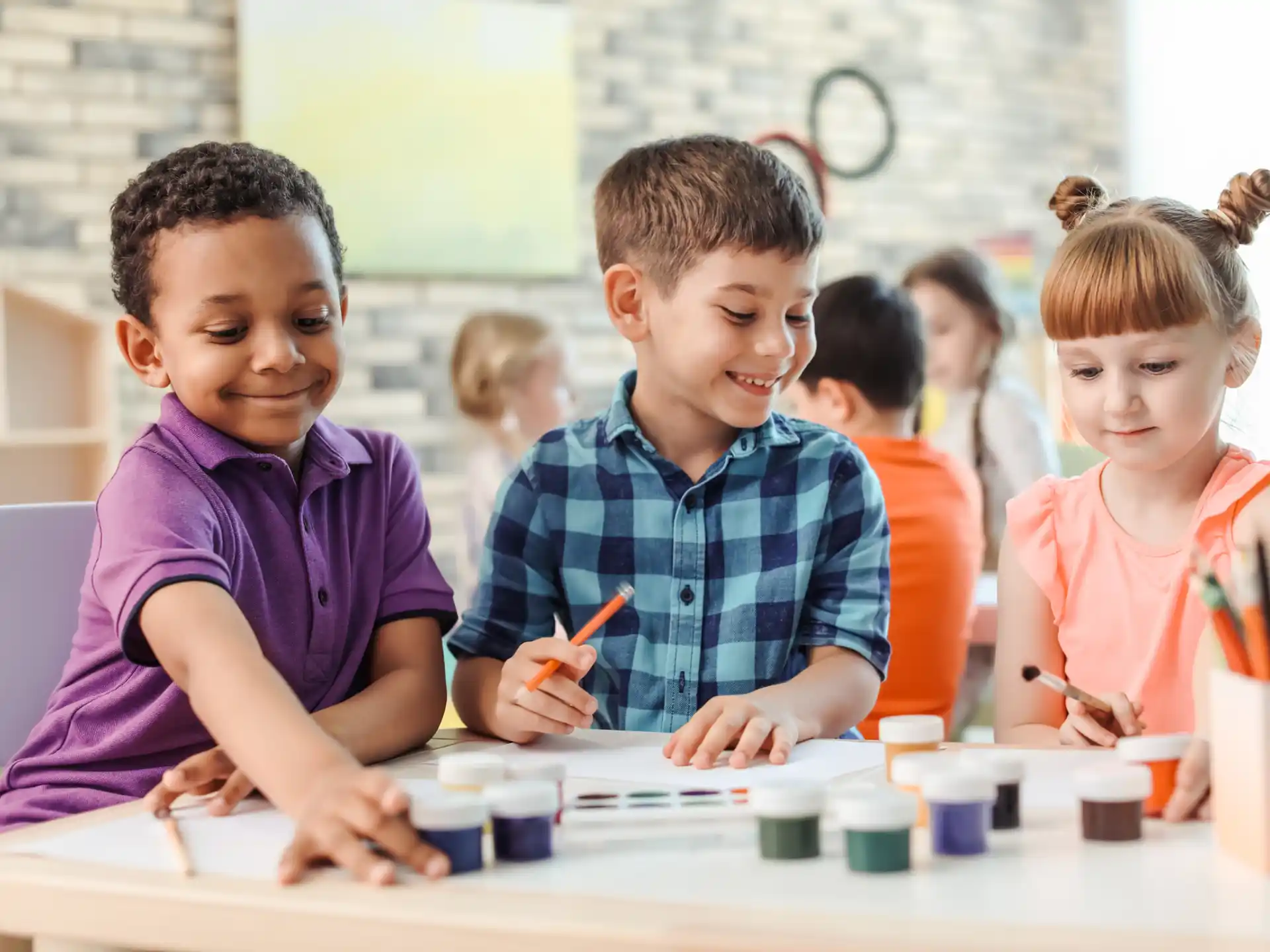 a group of children sitting at a table