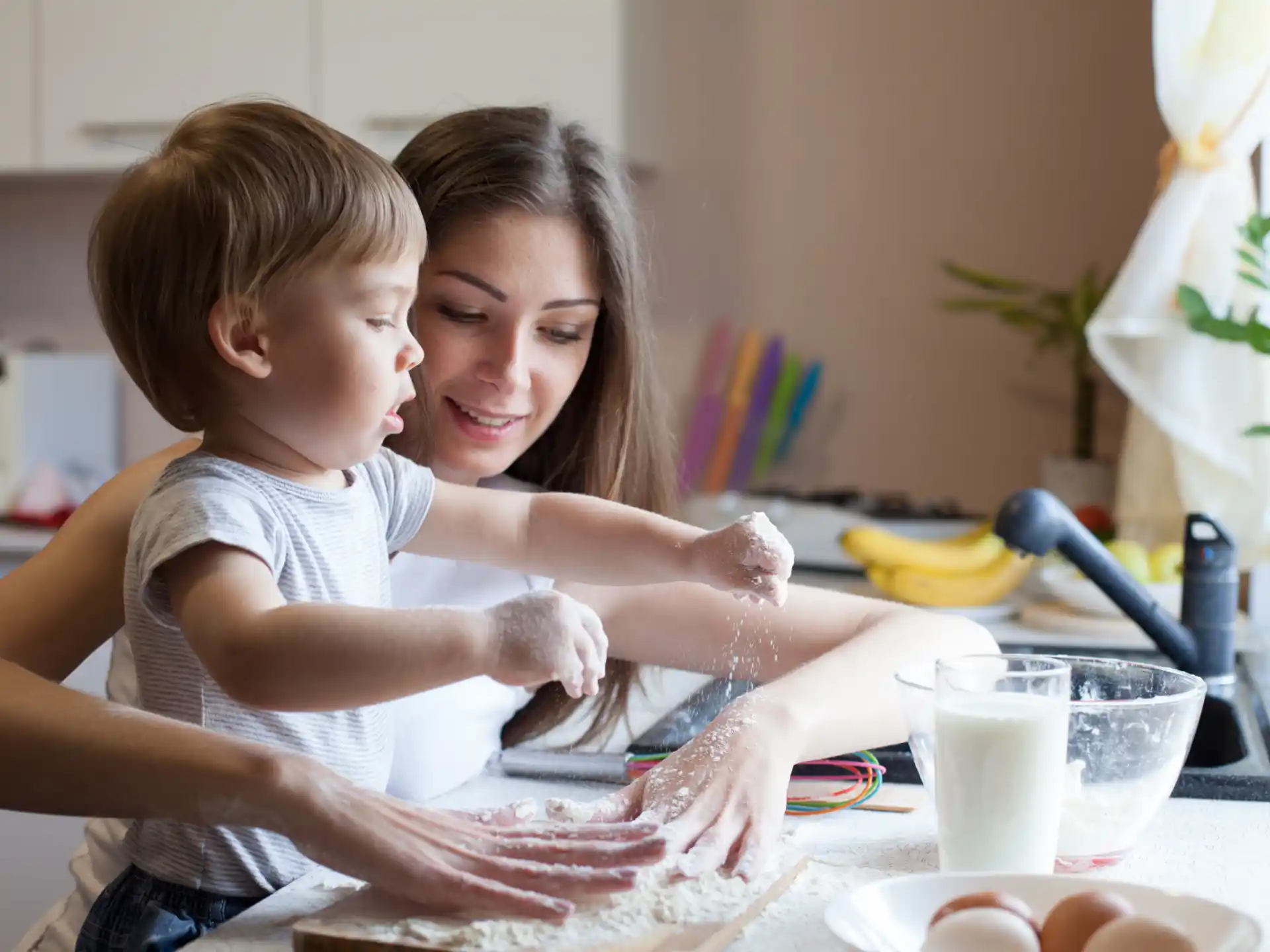 a woman and a child playing with sand