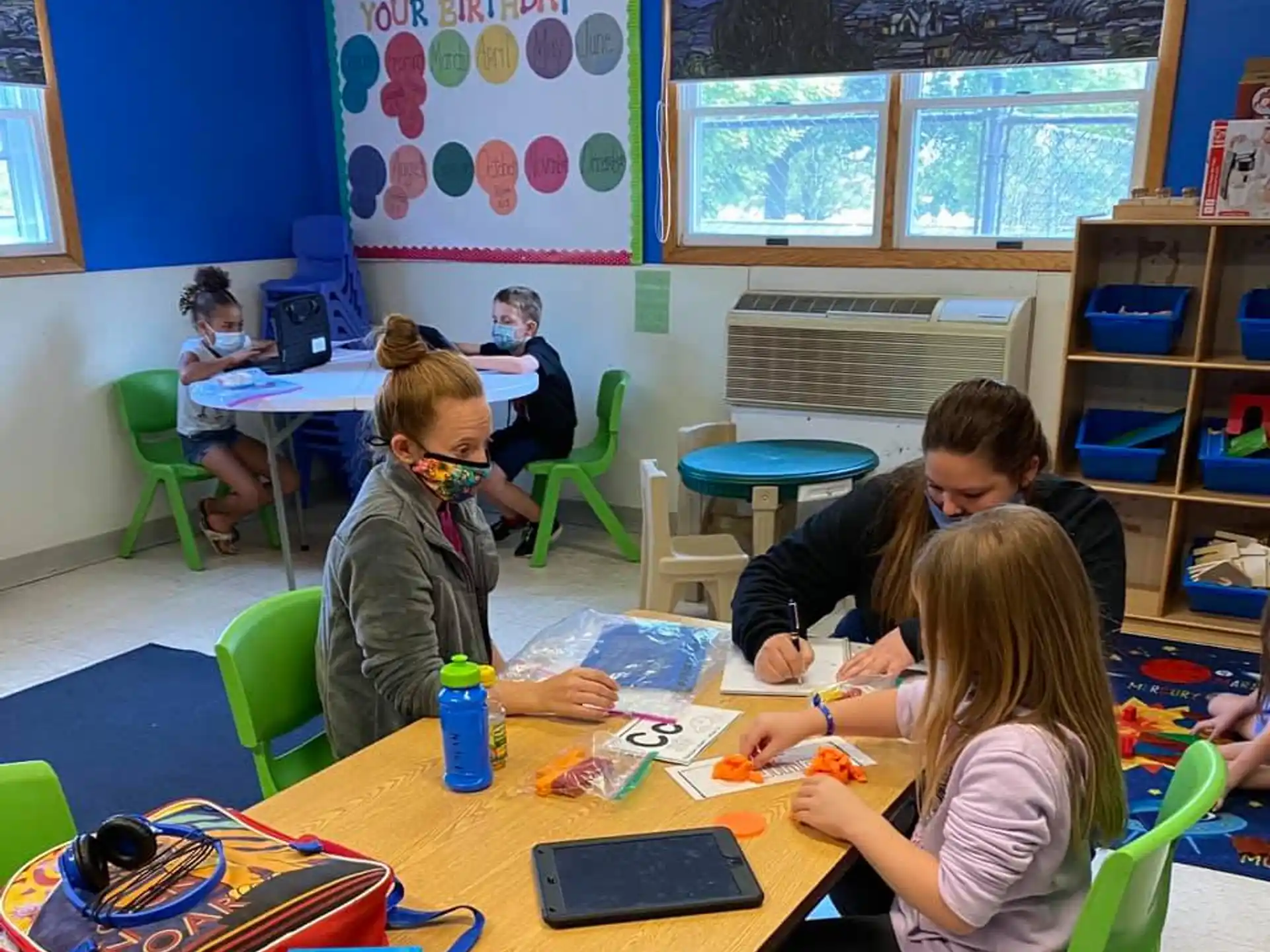 a group of children sitting at a table