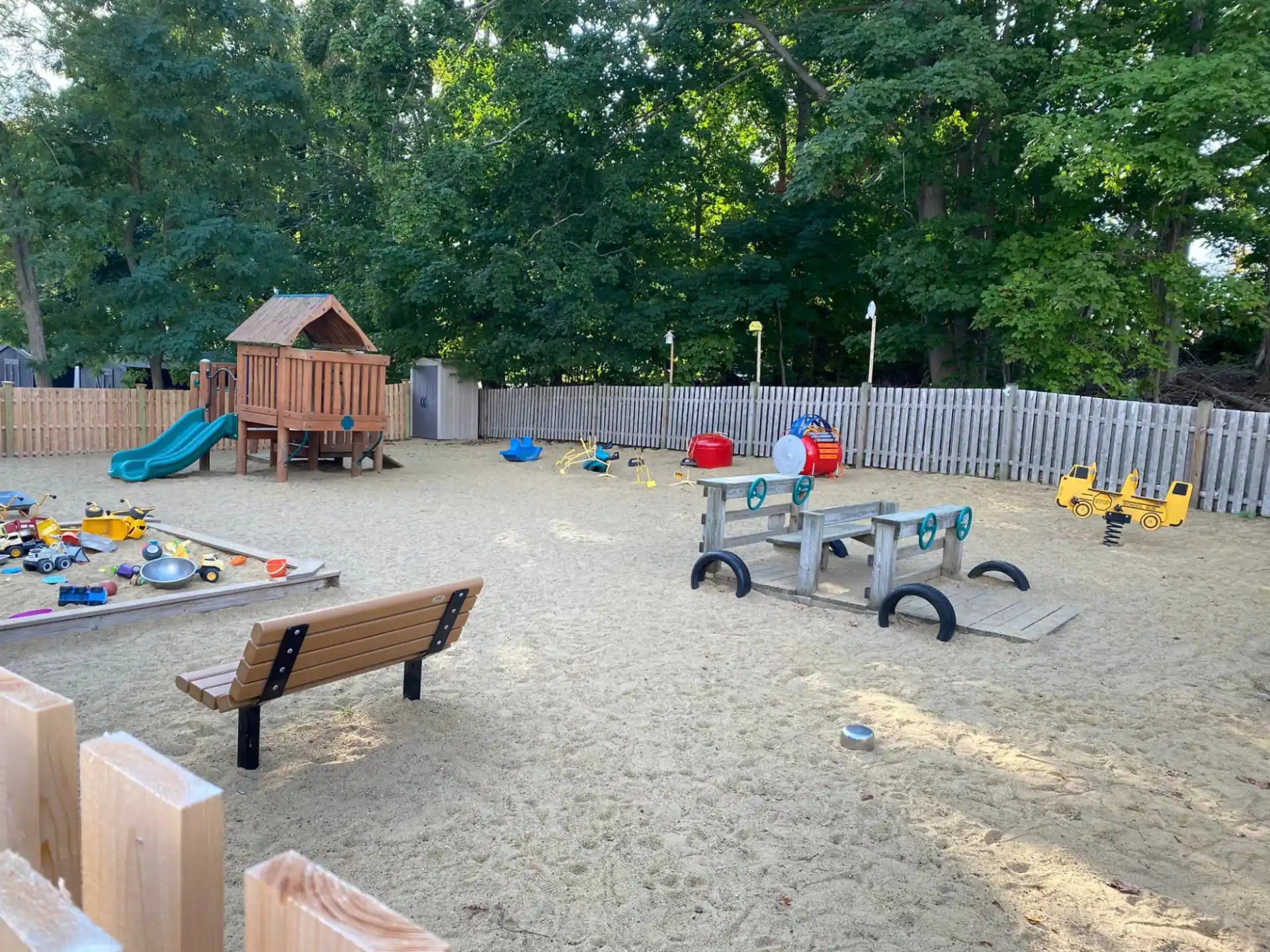 a backyard with a picnic table and benches