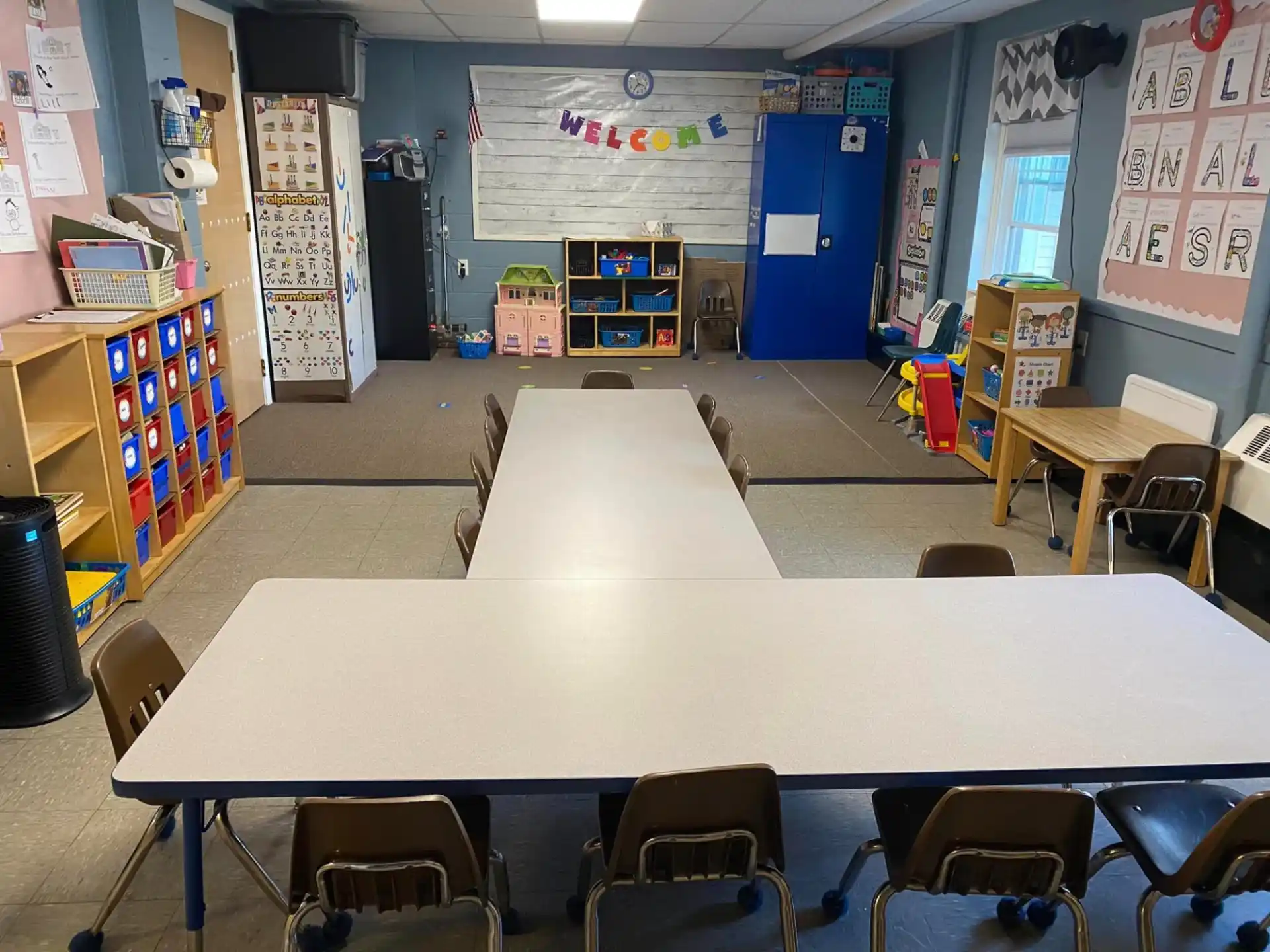 a classroom with tables and chairs