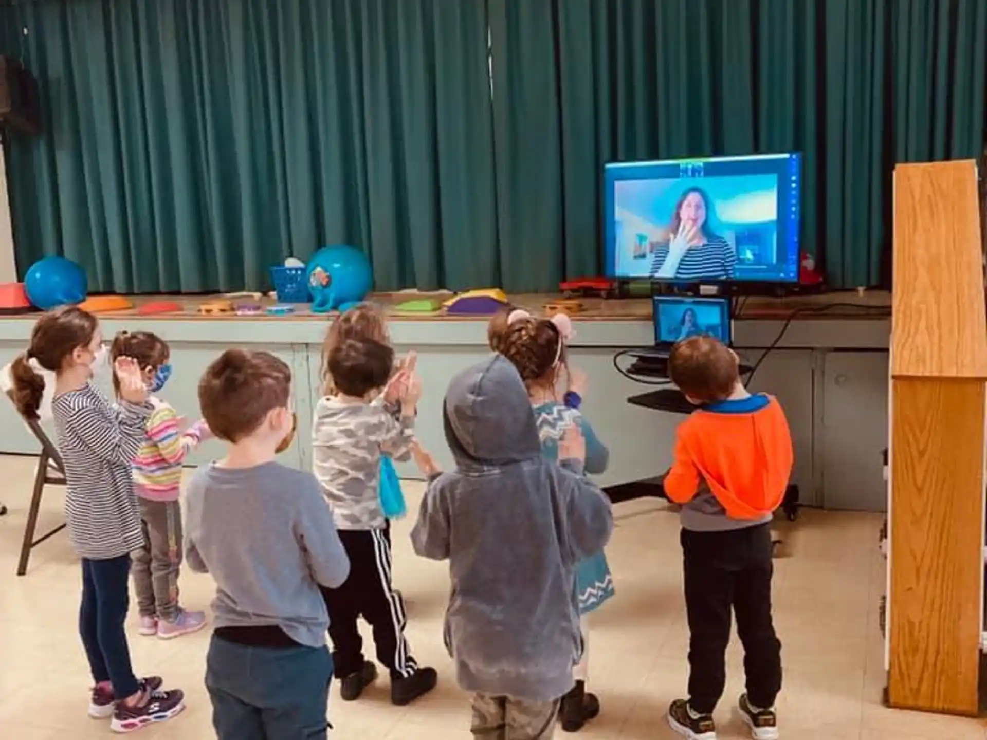 a group of children watching a television