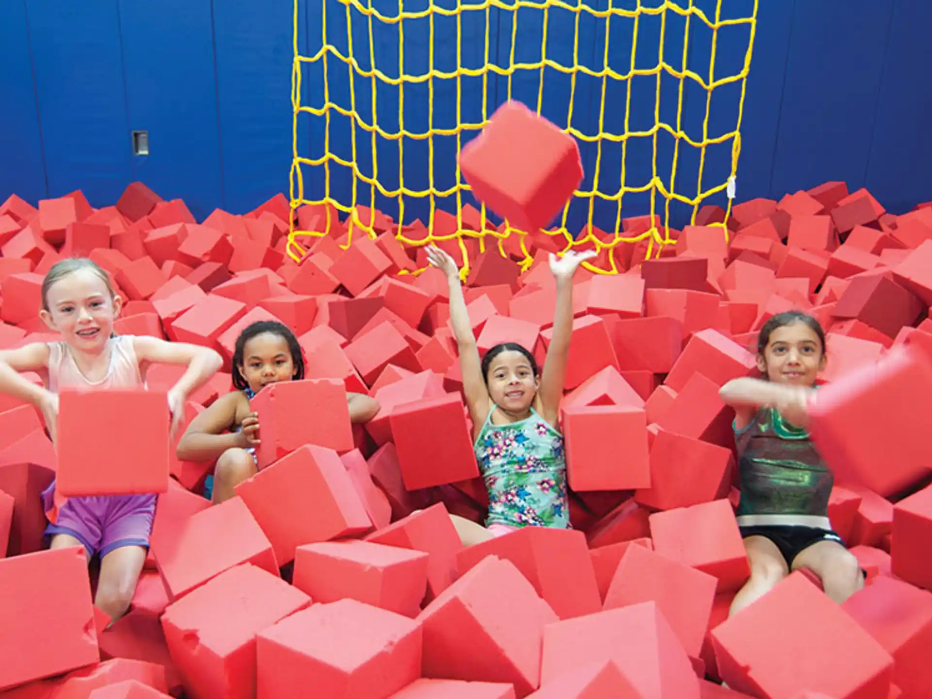 a group of children in a large red and blue play structure