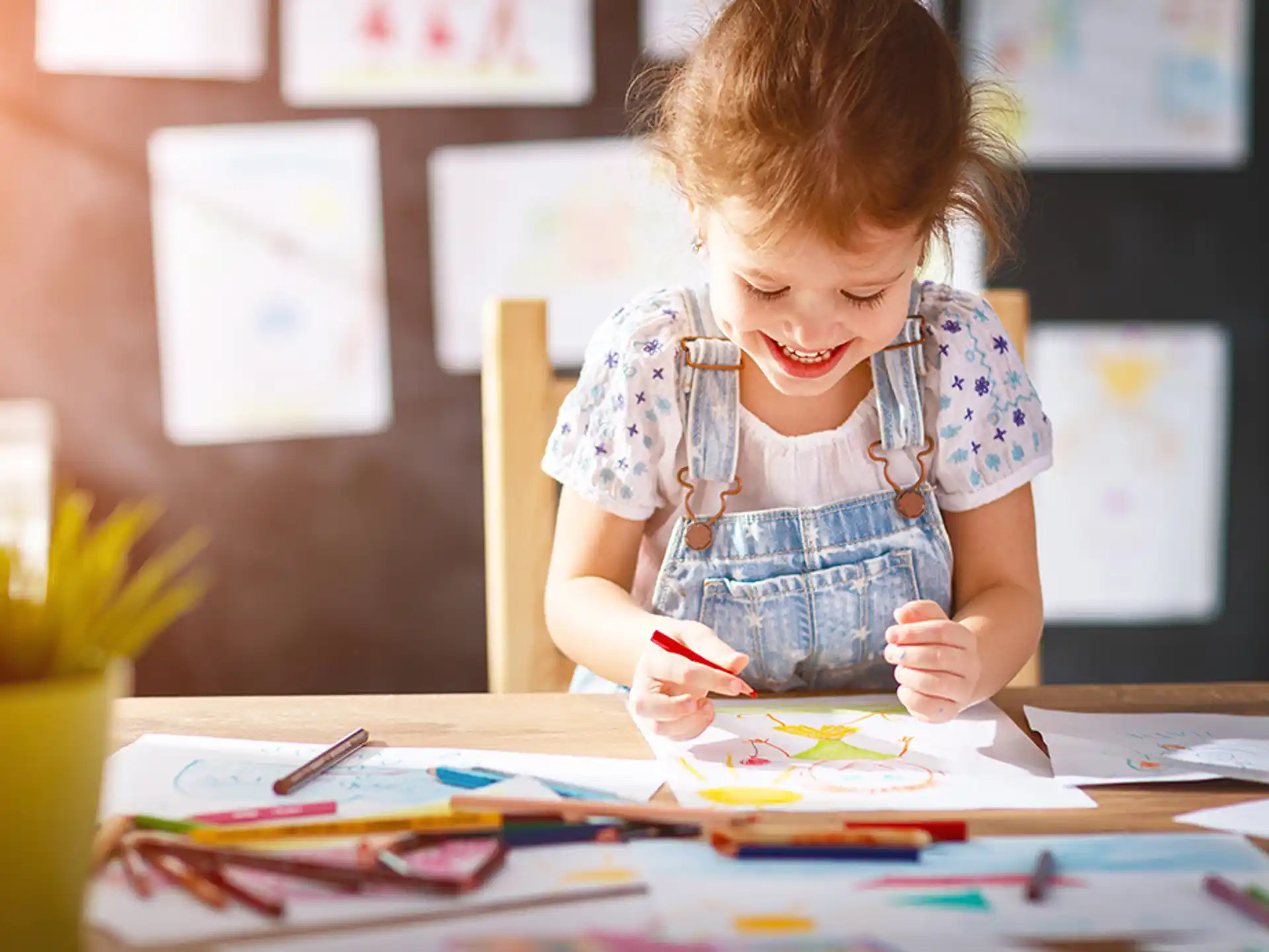 a young girl coloring on a table