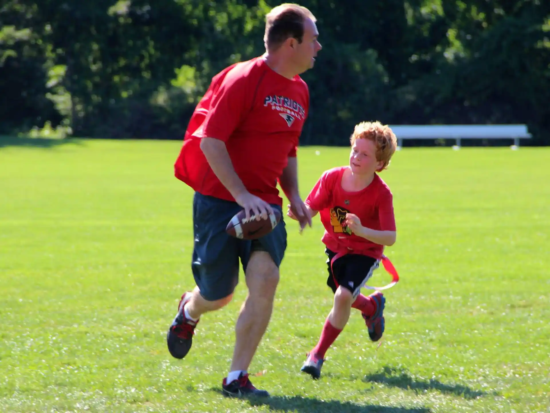 a person and a boy running on a field
