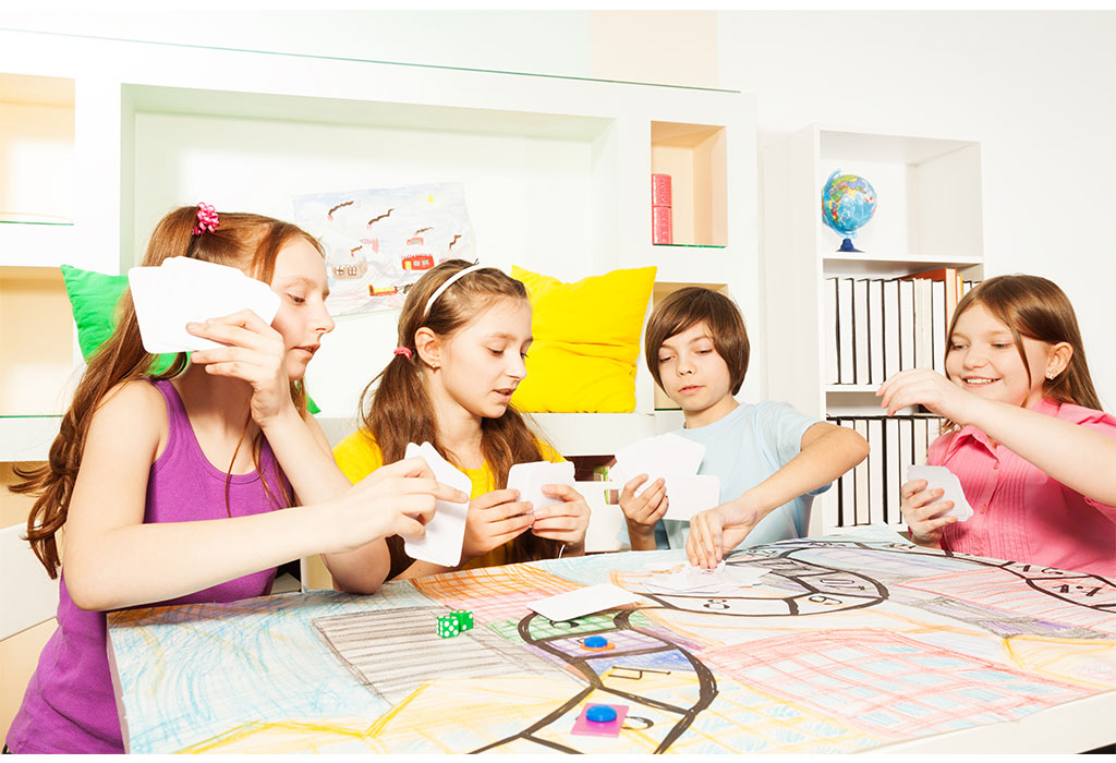 a group of children sitting around a table