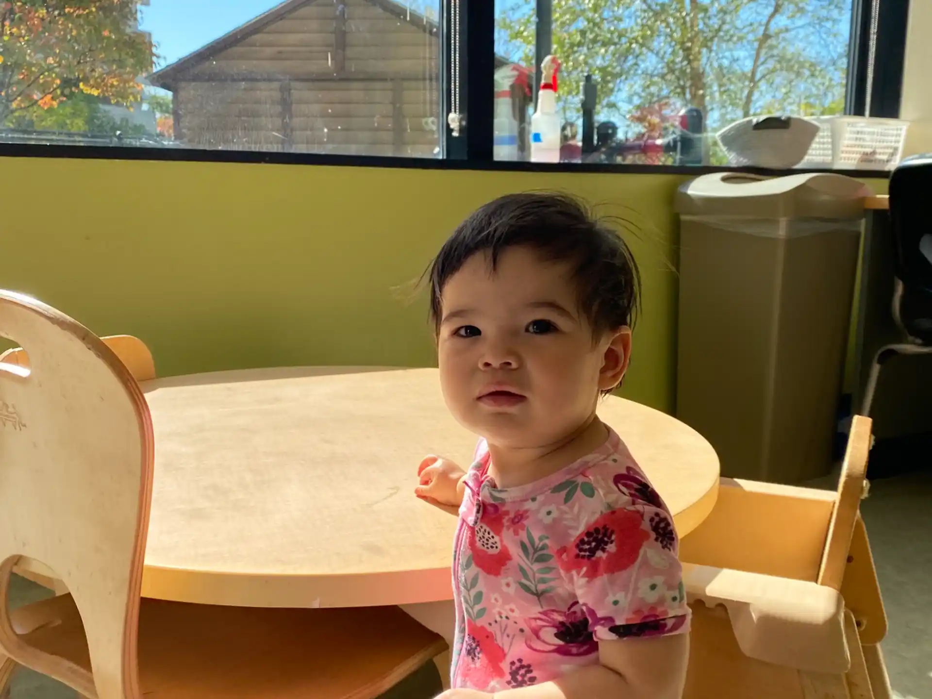 a child standing by a table