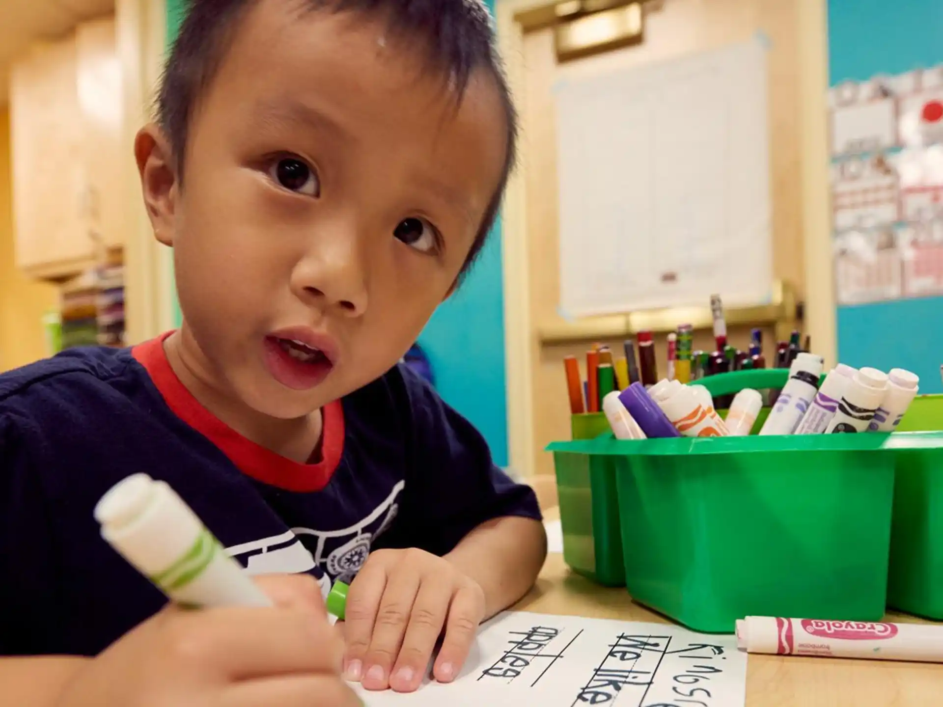 a child sitting at a desk