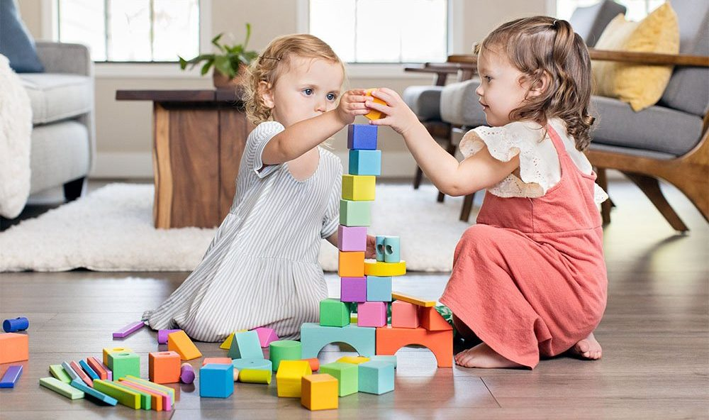 a couple of children playing with toys
