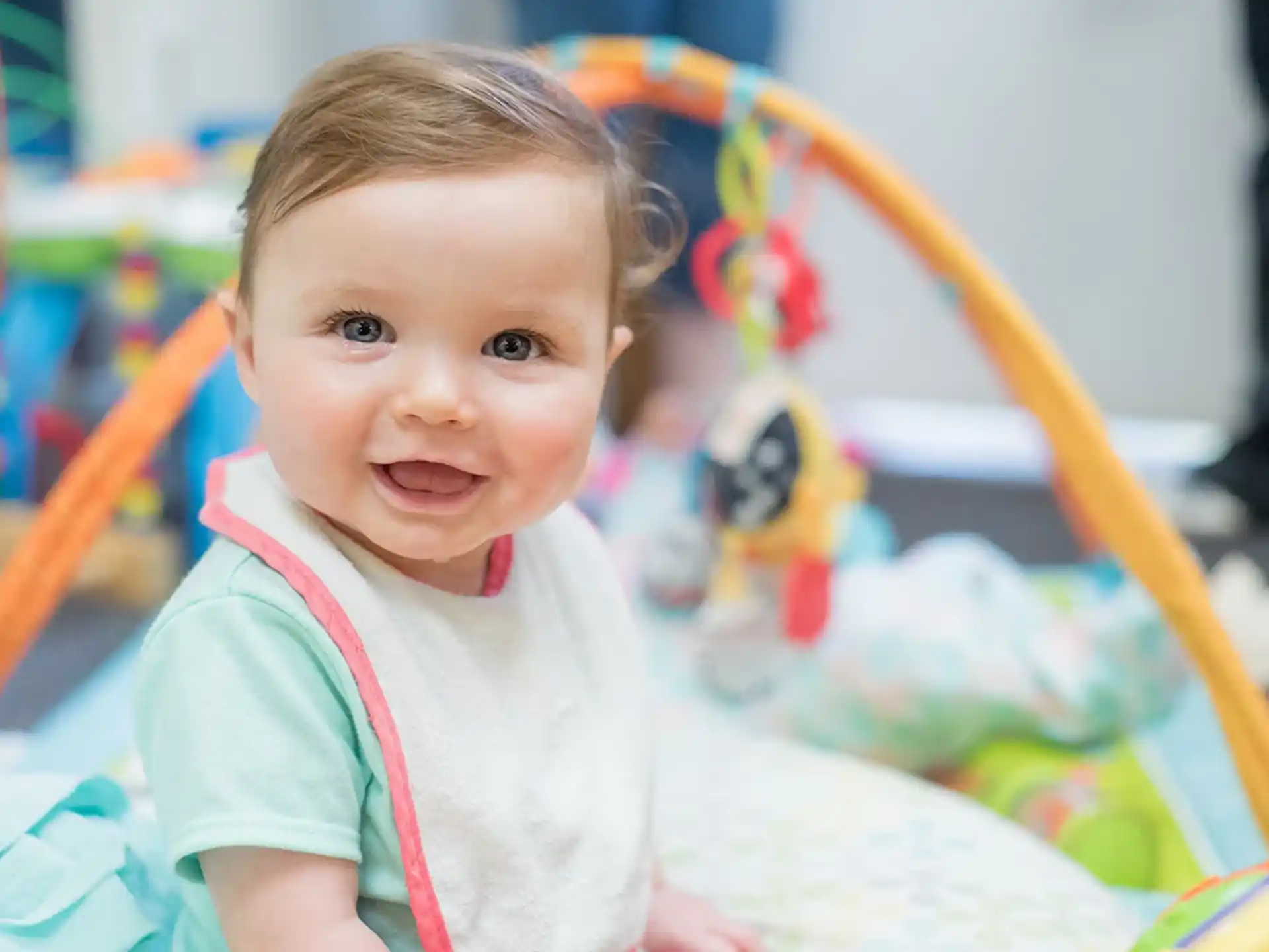 a baby sitting on a bed